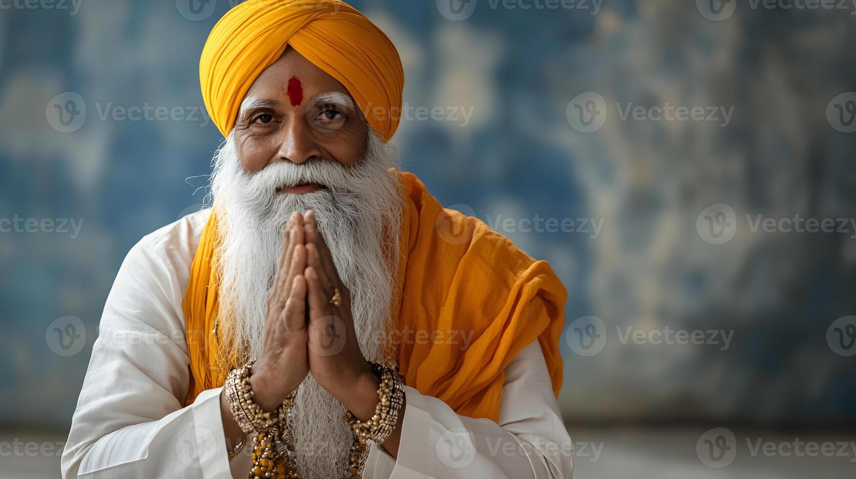 An old man with a white beard and yellow turban photo