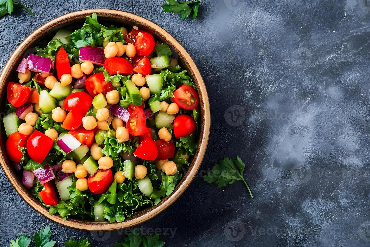A bowl of salad with tomatoes, cucumbers and chickpeas photo