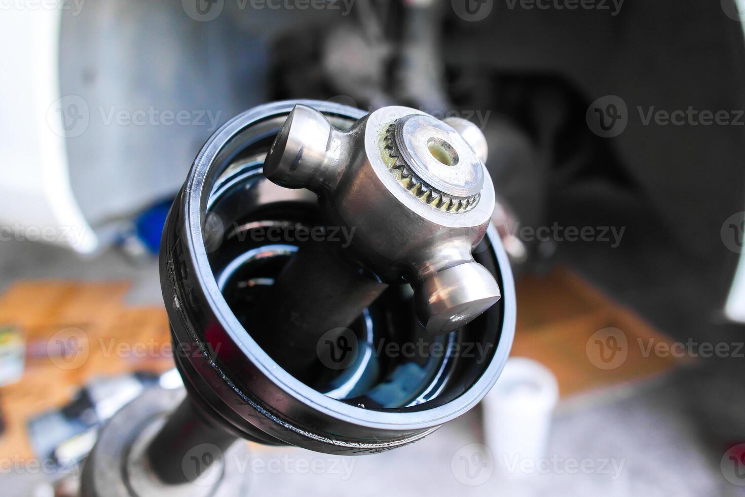 Close up of front drive axle damaged of car photo