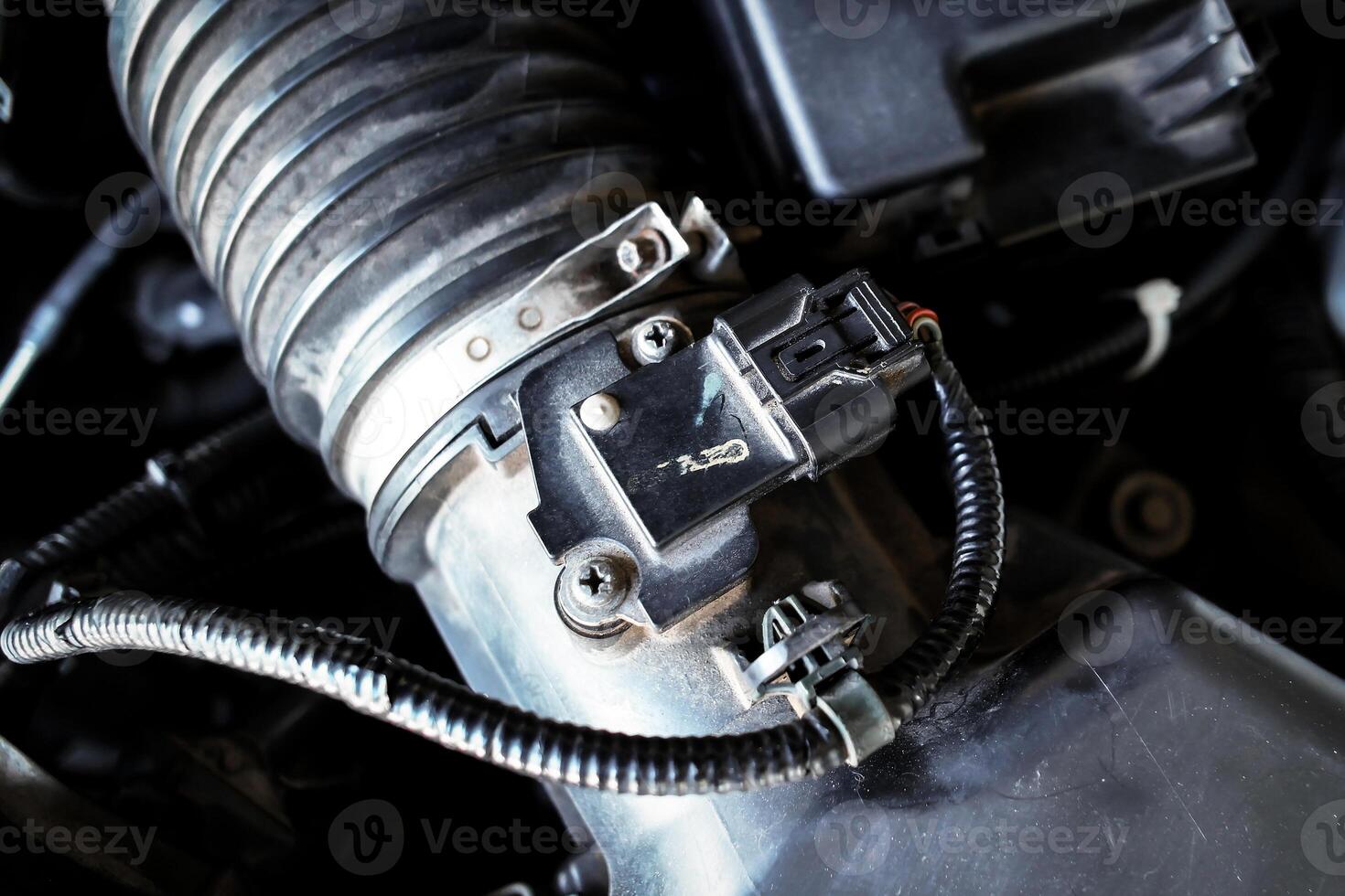 Close-up of automotive mass airflow sensor on air intake manifold of car combustion engine , Automotive parts concept photo