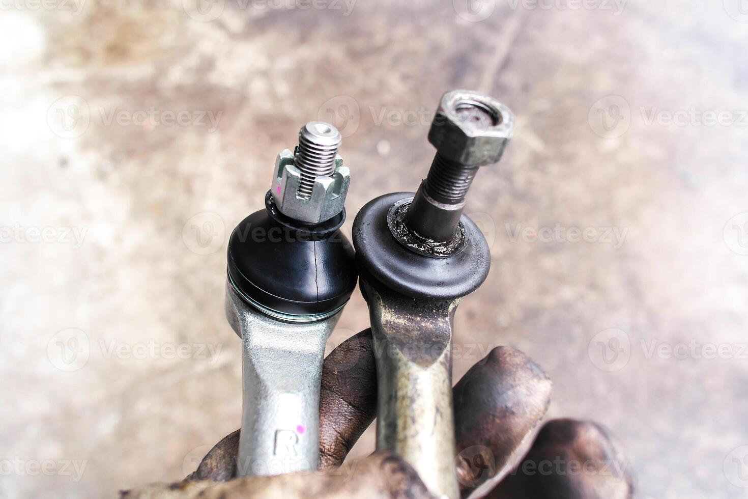 Close up of automotive tie rod ends comparison new and old photo