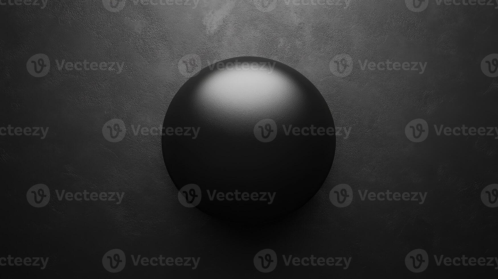 Dark sphere shaped form with a bright highlight on a textured surface photo