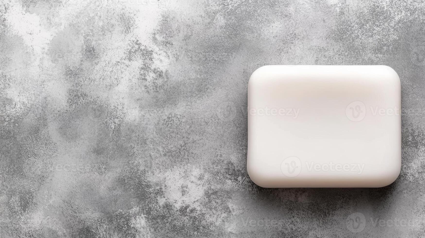 White Bar of Soap on a Textured Gray Background photo