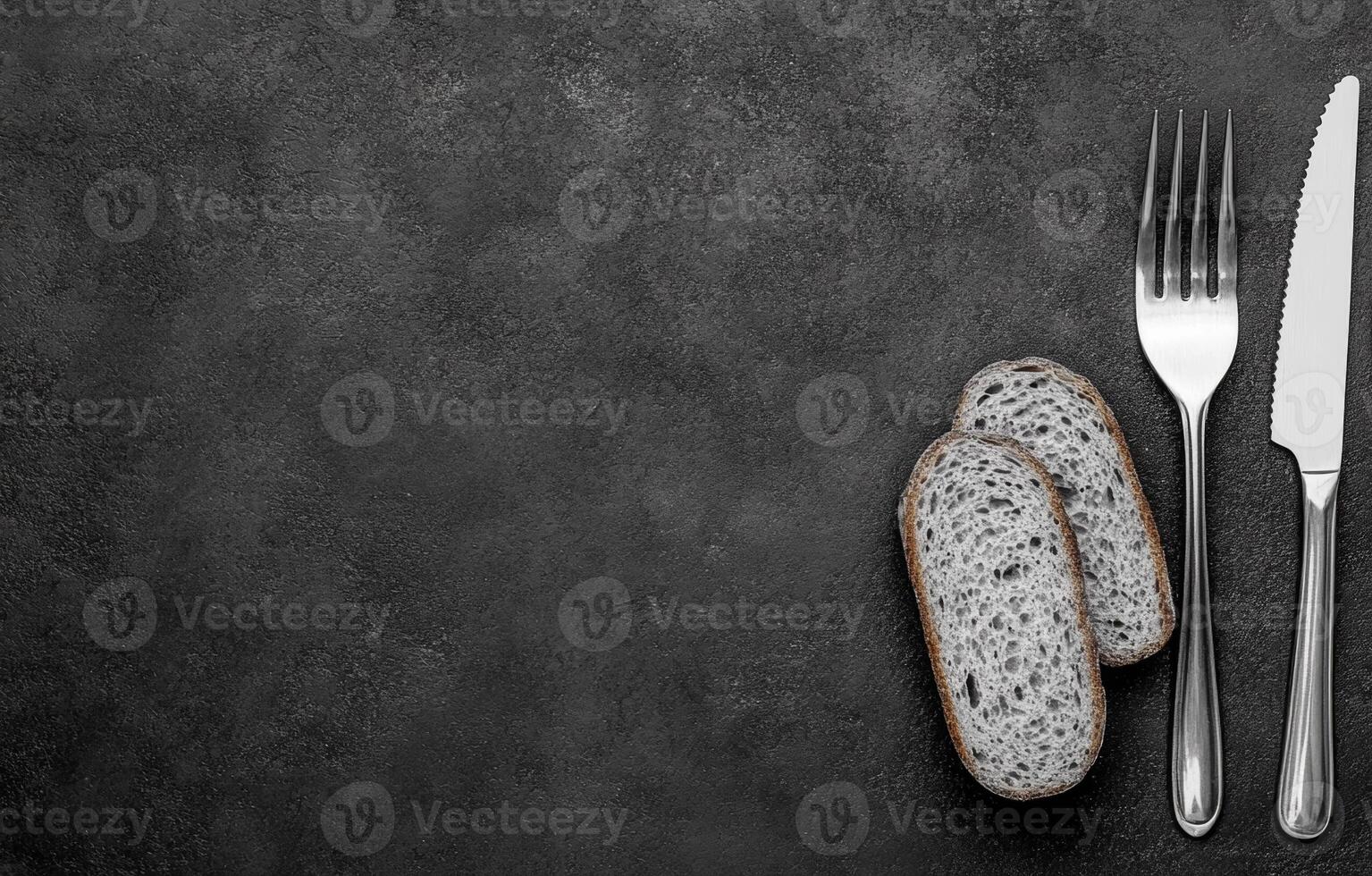Dark Table Setting with Bread and Silverware photo