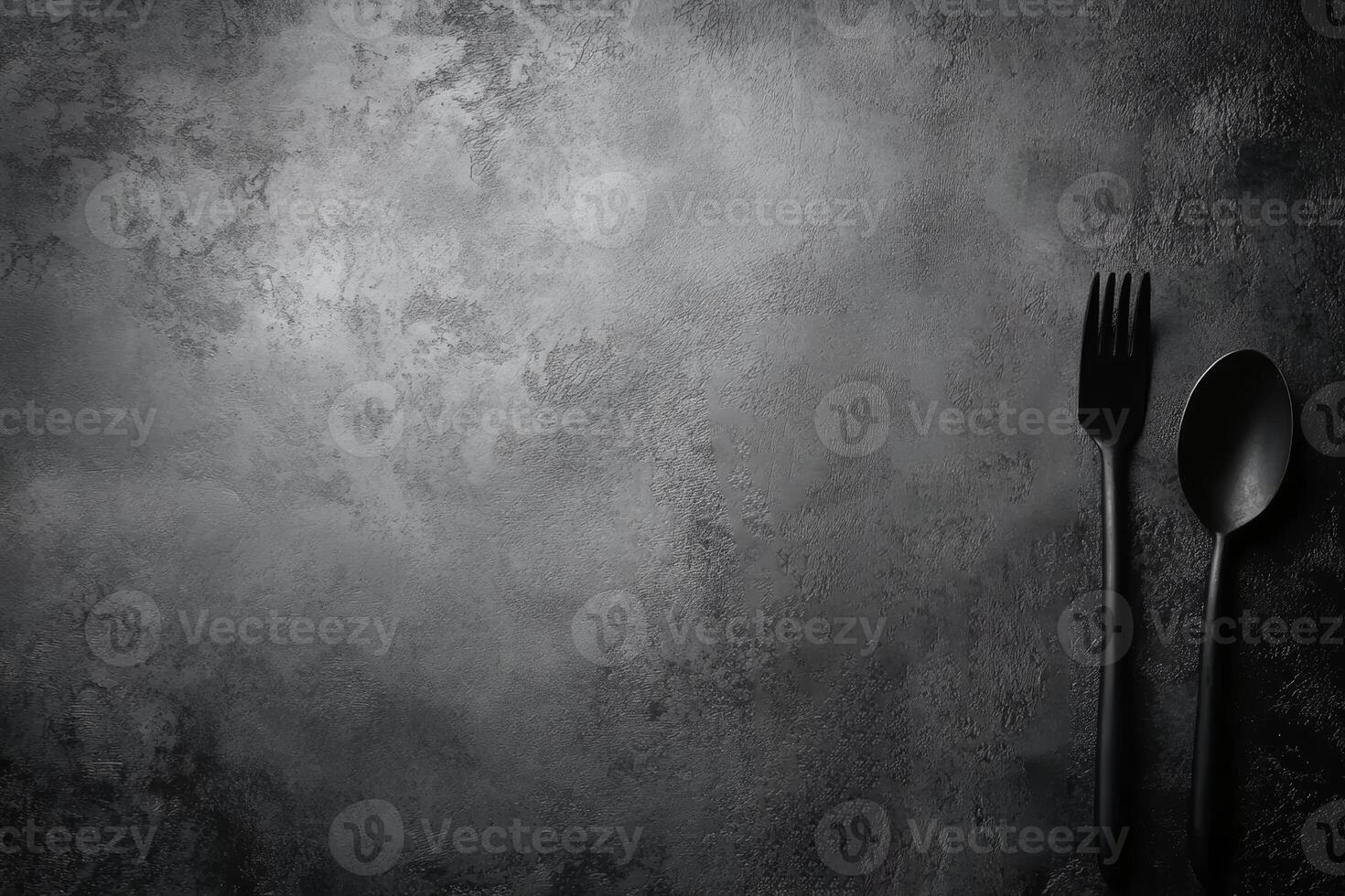 Monochrome Utensils on a Dark Textured Tabletop photo