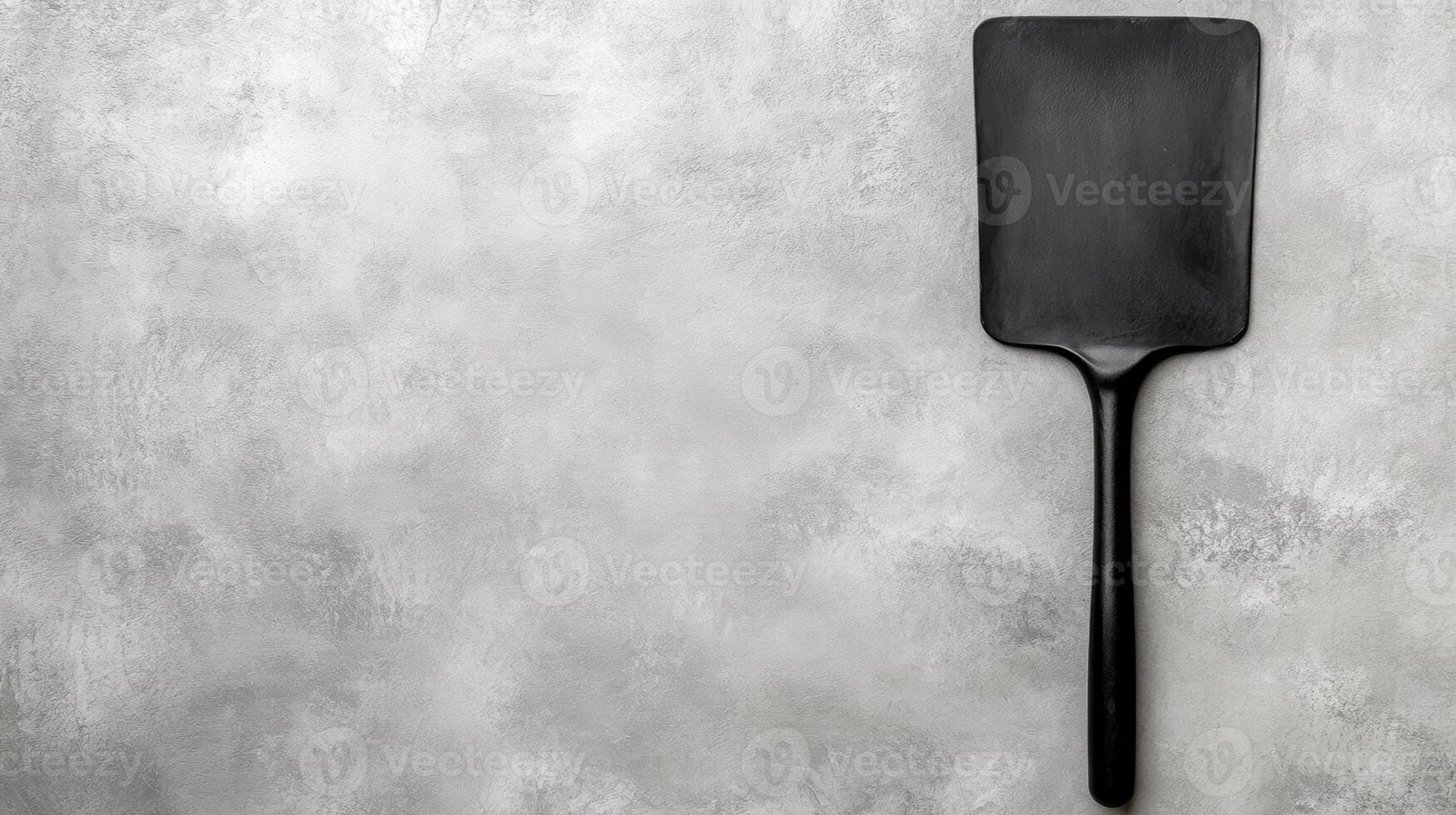 Black Cooking Spatula on a Gray Textured Background photo