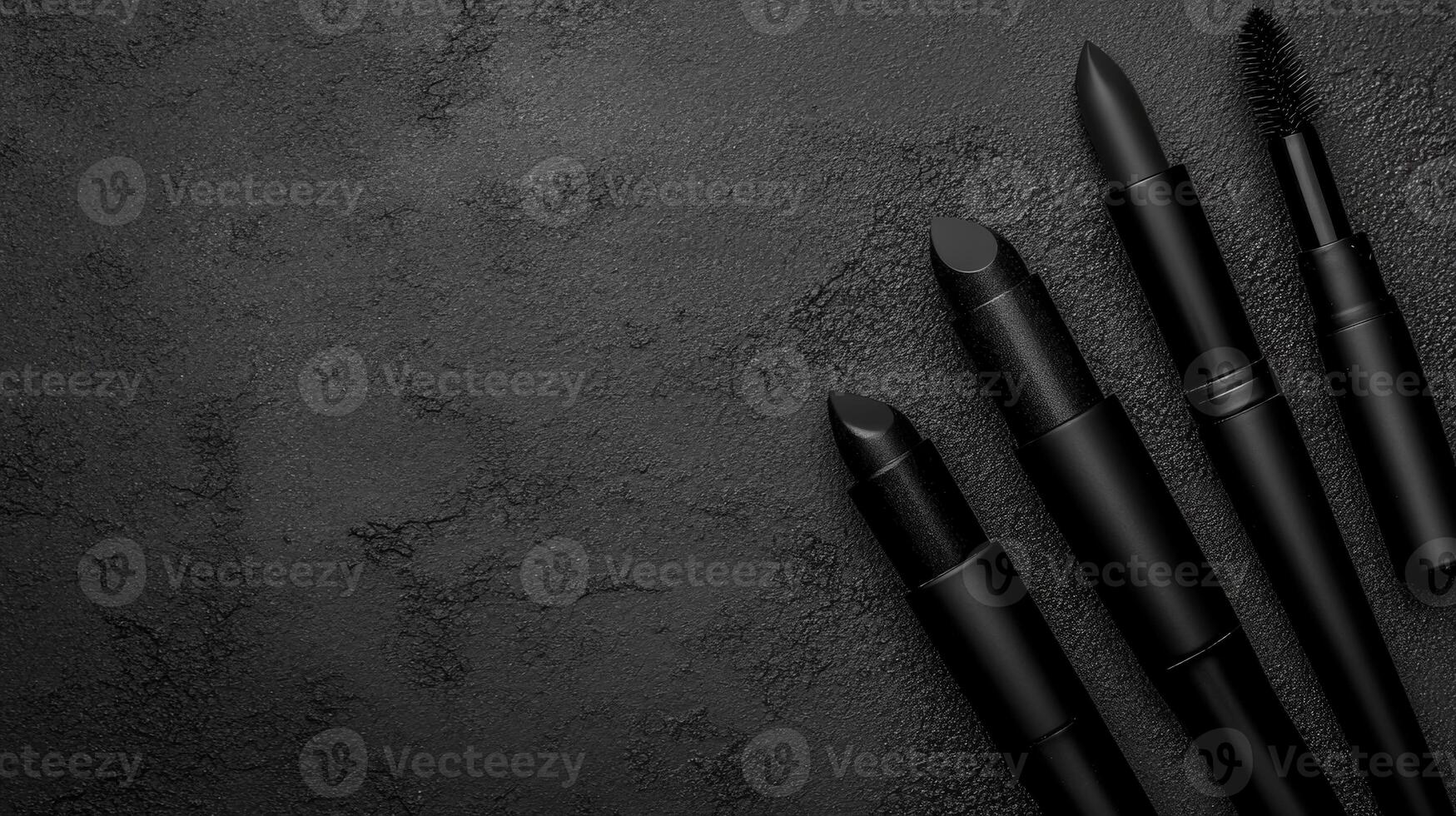 Monochrome Makeup Tools on Textured Dark Surface photo