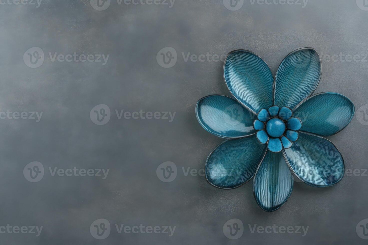 Blue Ceramic Flower on Textured Gray Surface, Flat Lay photo
