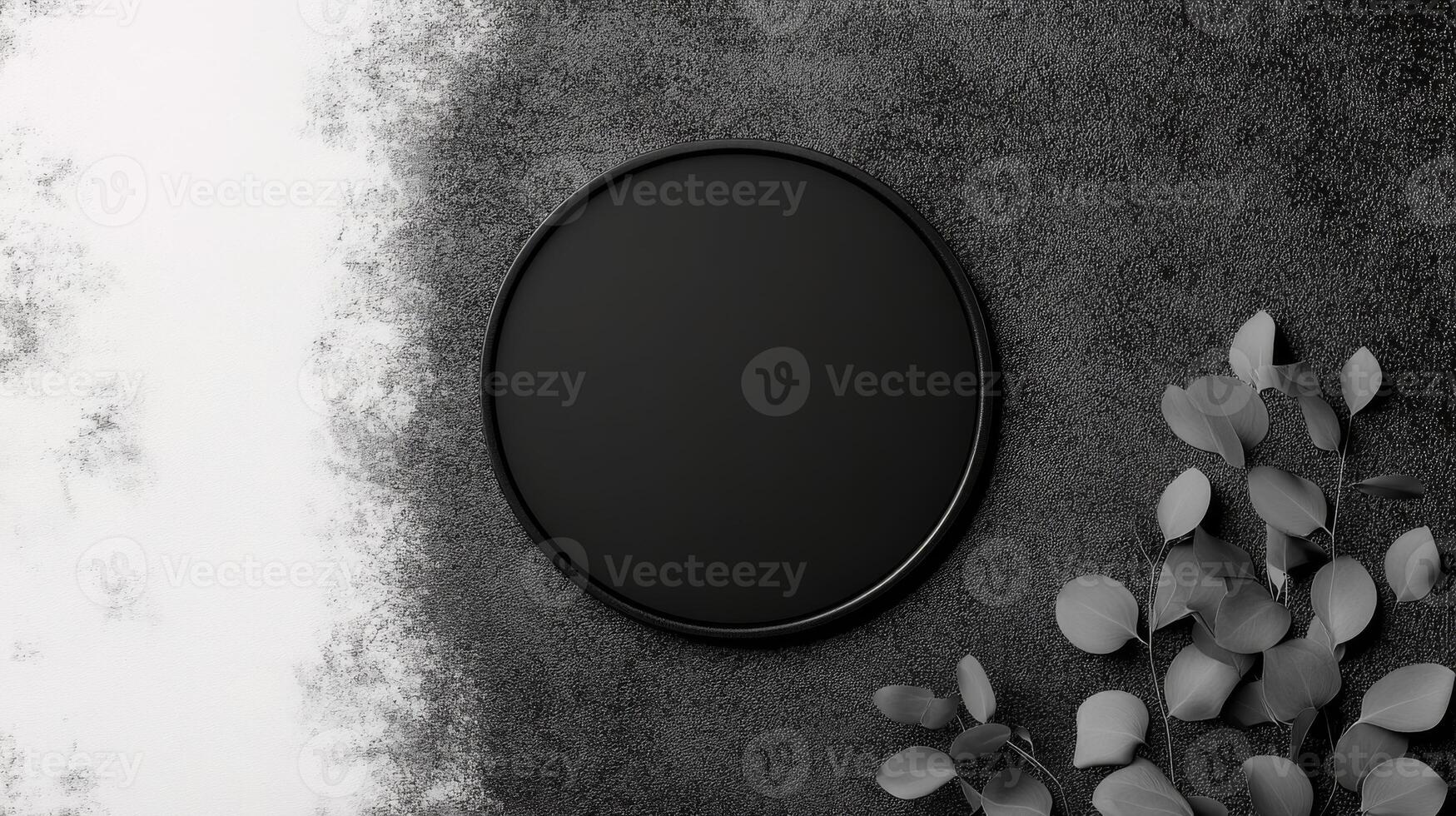 Minimalist Black Circle with Delicate Leaves on Textured Gray Surface photo