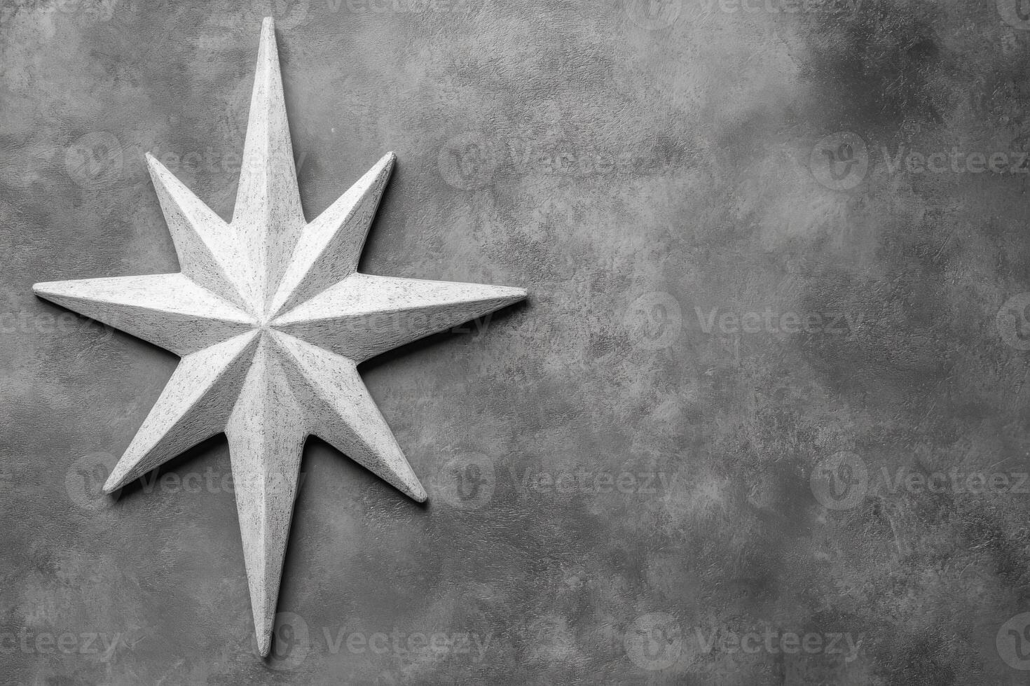 Carved White Star Symbol on a Textured Gray Stone Surface photo