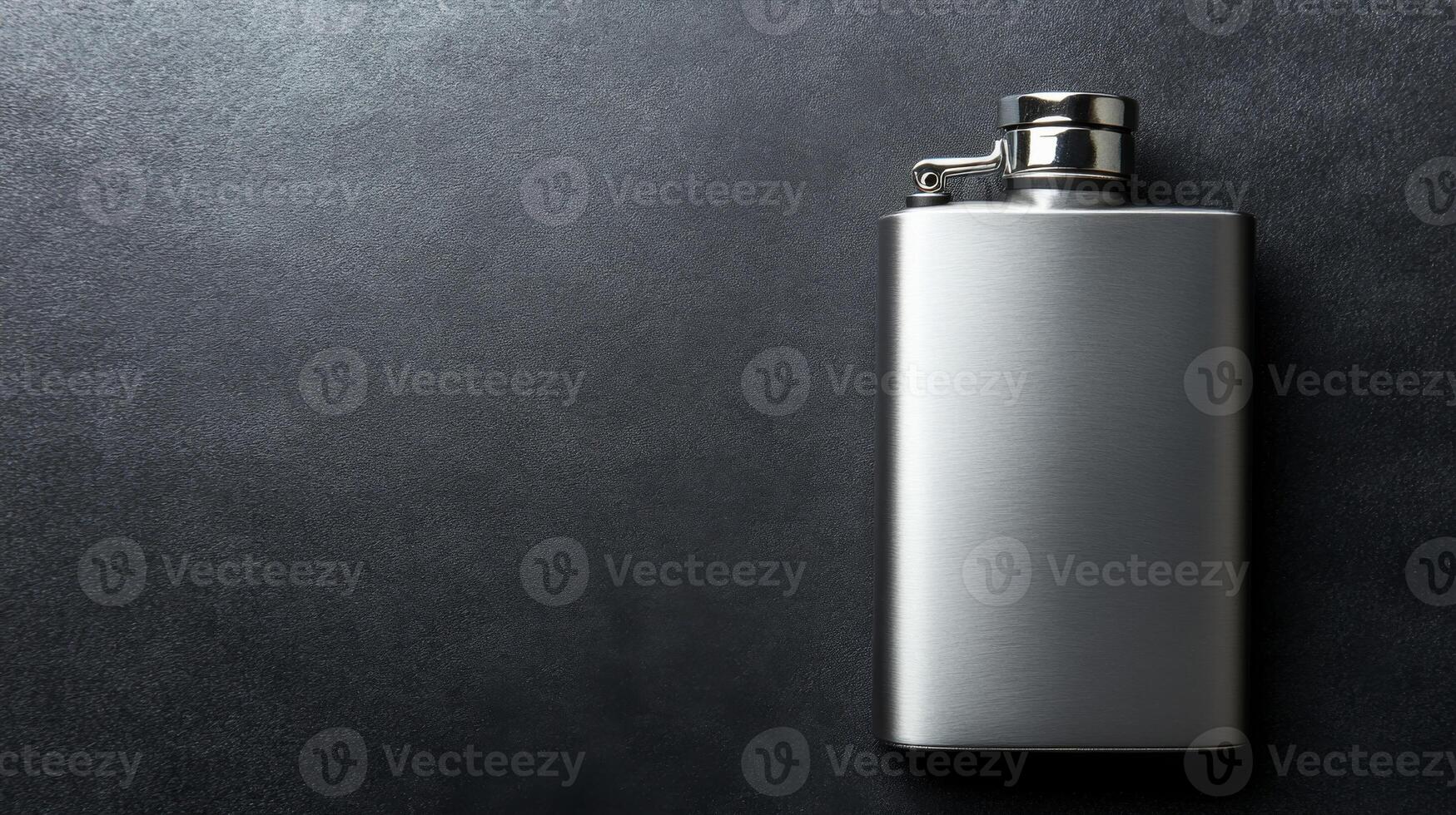 Polished Silver Flask with a Hinged Cap on a Dark Textured Surface photo