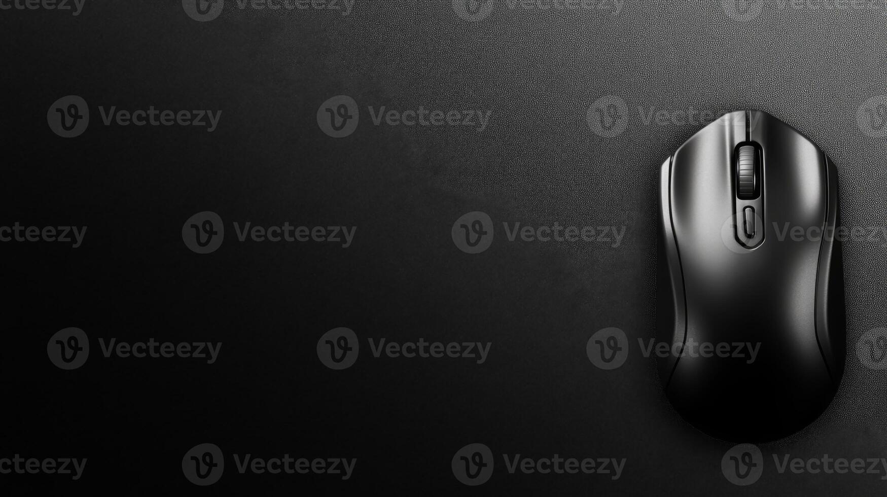 Sleek Black Computer Mouse on a Smooth Dark Surface photo