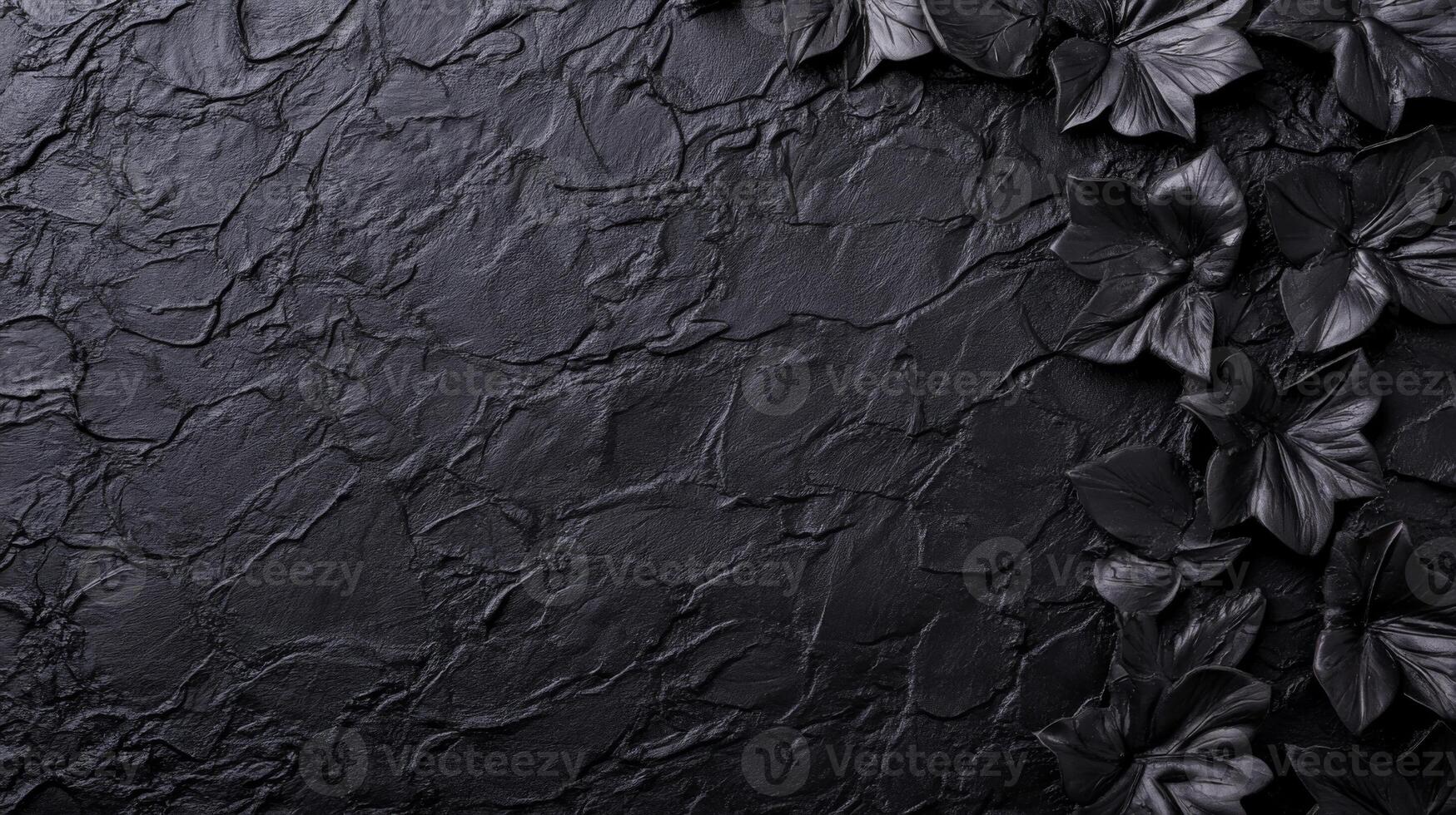 Dark Textured Stone Surface with Black Floral Accents in Monochrome Contrast photo