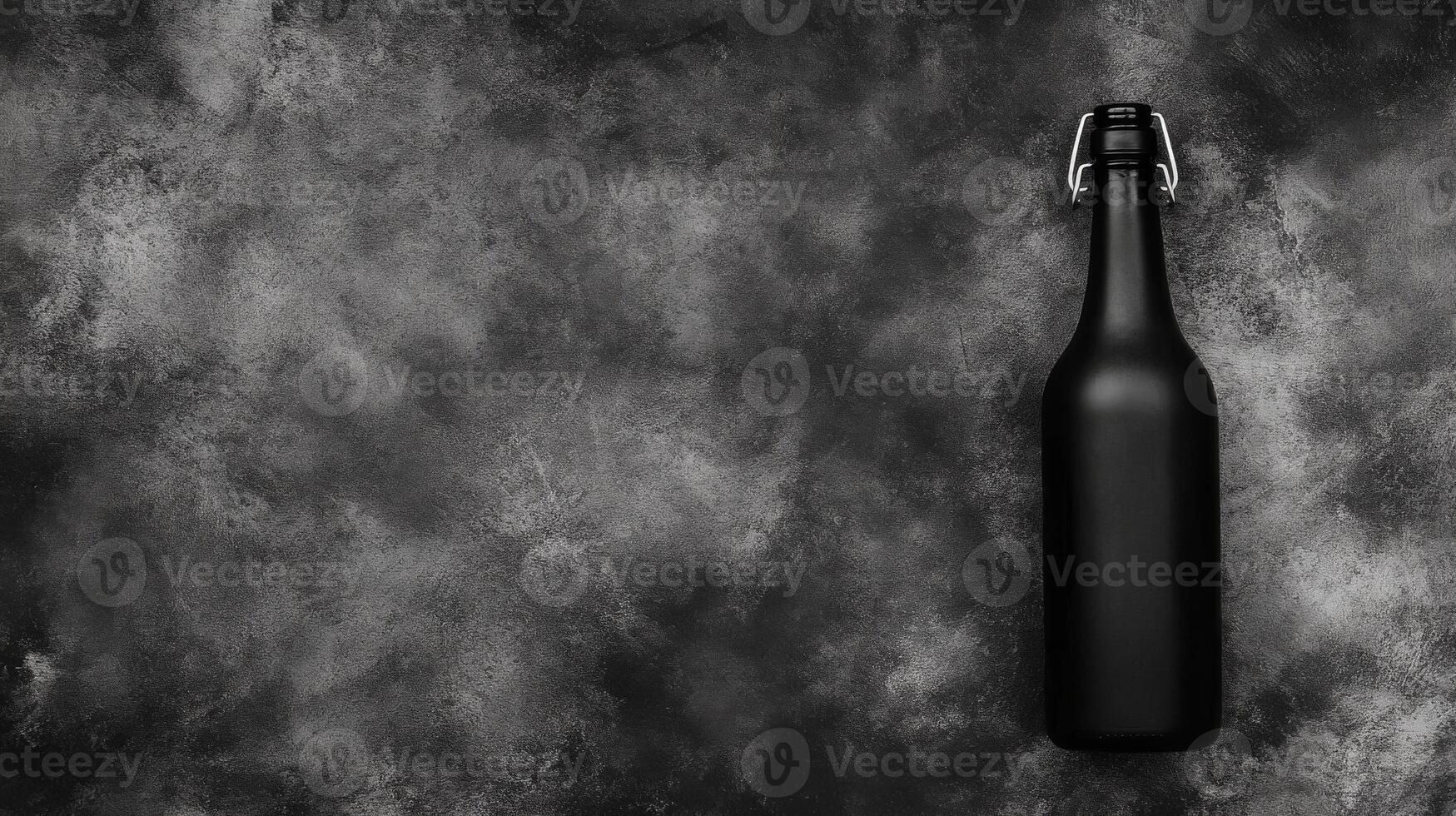 Sleek Black Bottle with Swing Top Cap on a Textured Gray Surface photo