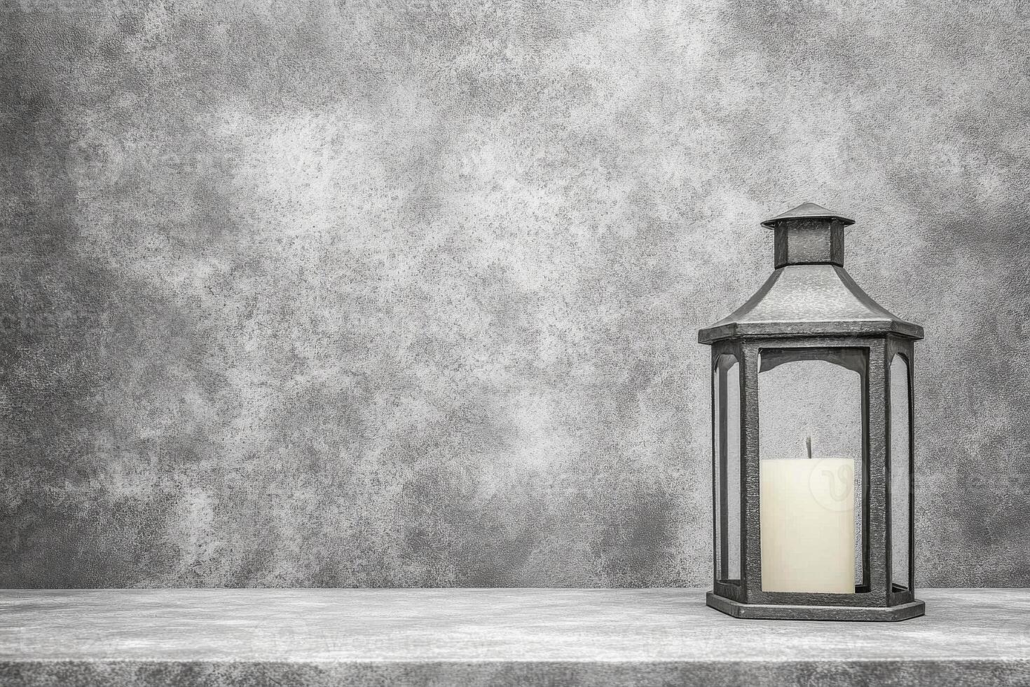 Metal Lantern with Unlit Candle on a Textured Gray Surface in Monochrome photo