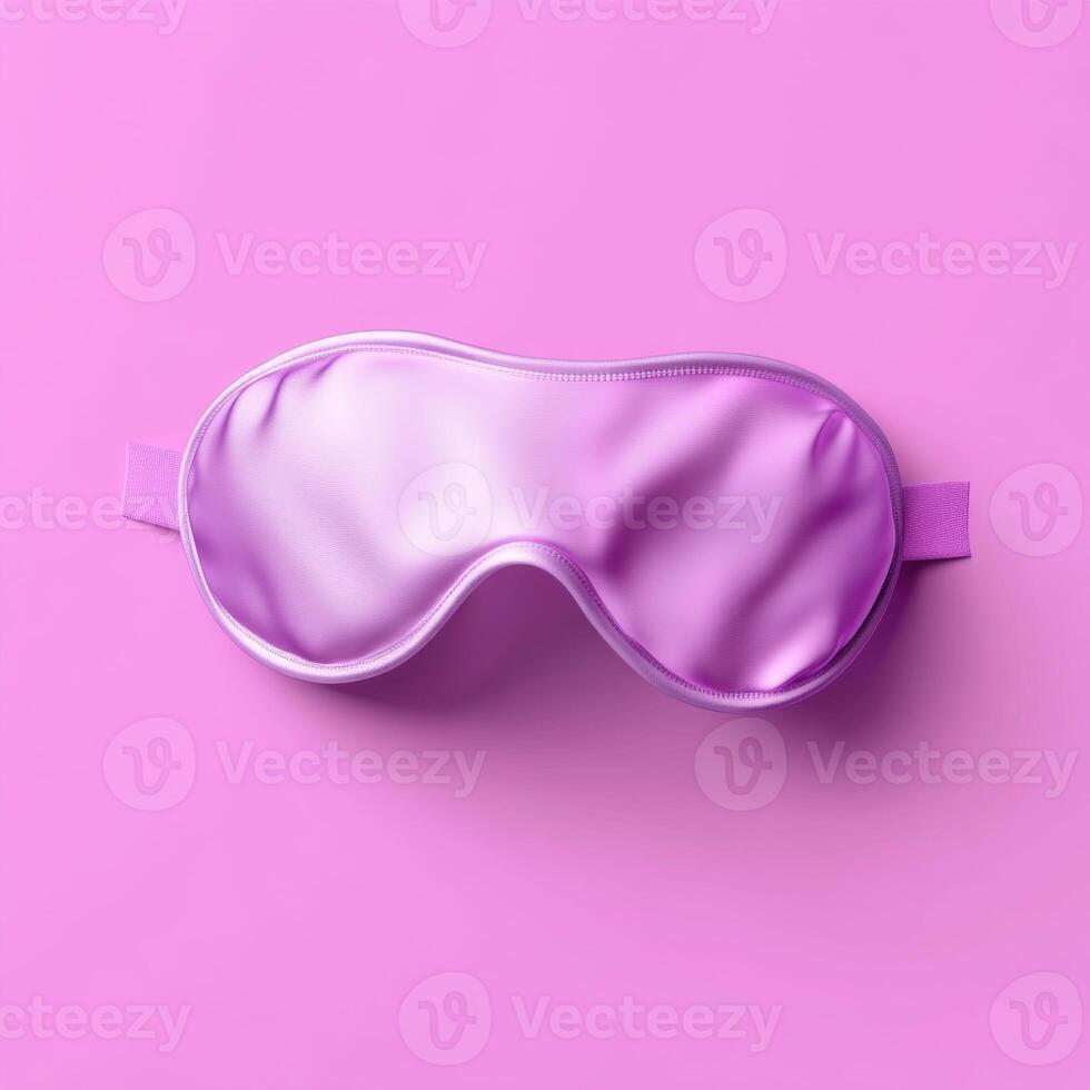 Shiny Pink Satin Sleep Mask Resting on Matching Background Surface photo