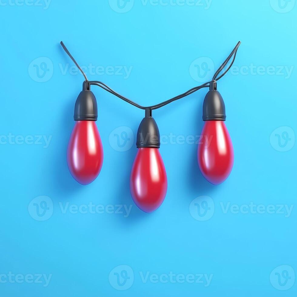 Three Matte Red Festive Bulbs Hanging on Black Wire Against Blue Surface photo