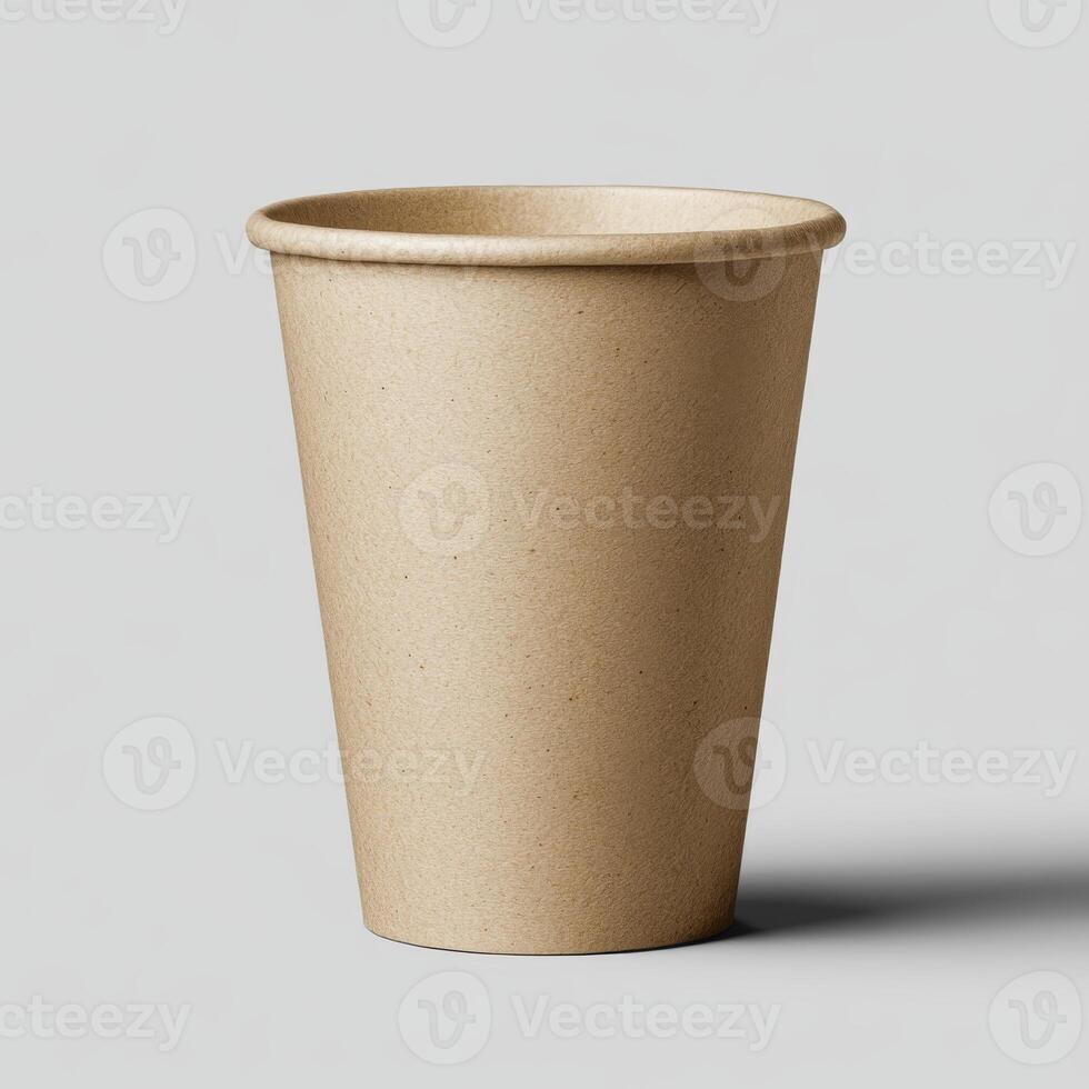 Empty Brown Paper Cup Standing Alone on a Plain Grey Surface photo