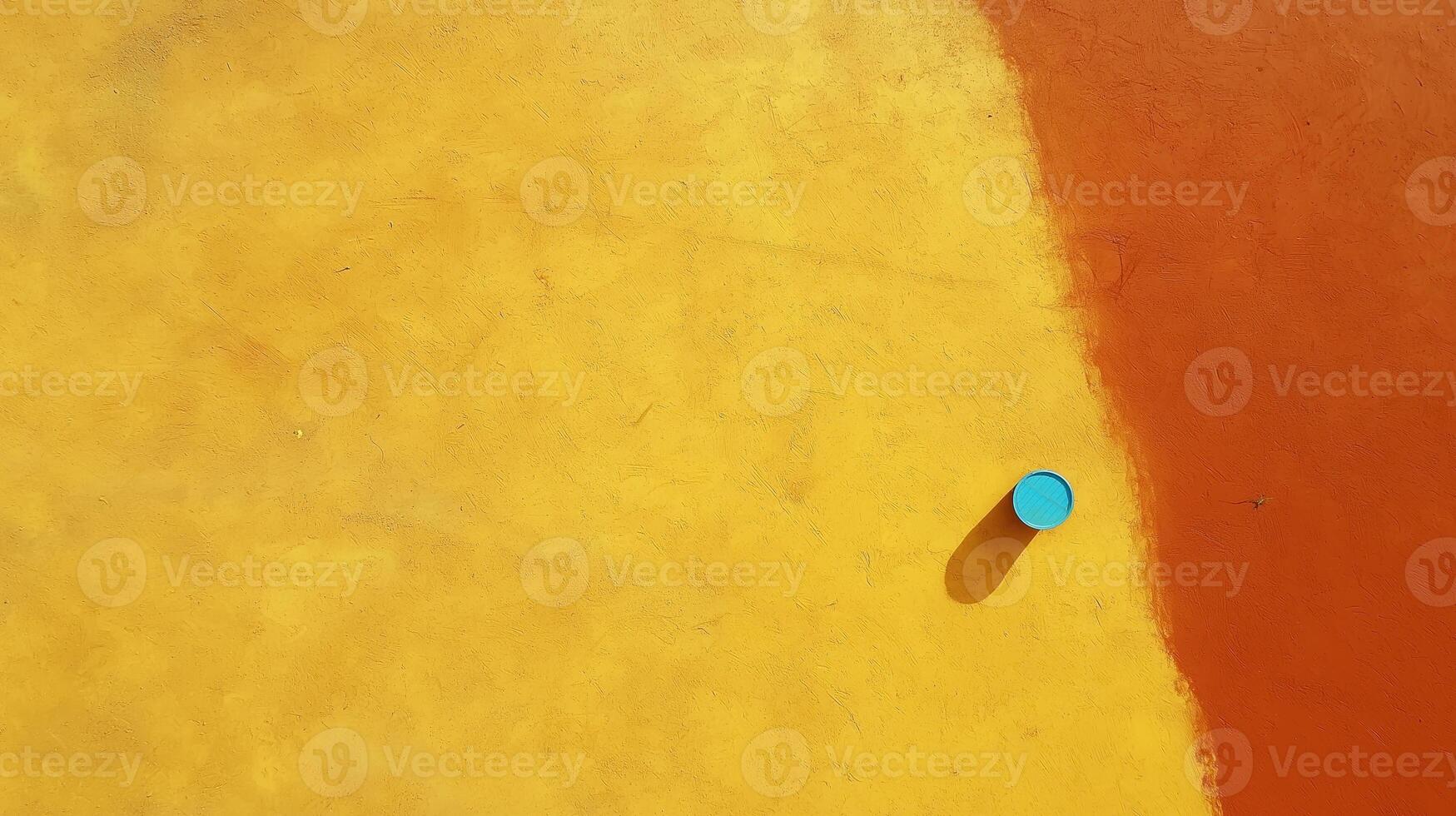 Colorful Abstract Background with Blue Circle on Bright Yellow and Orange Wall Surface for Design Use photo