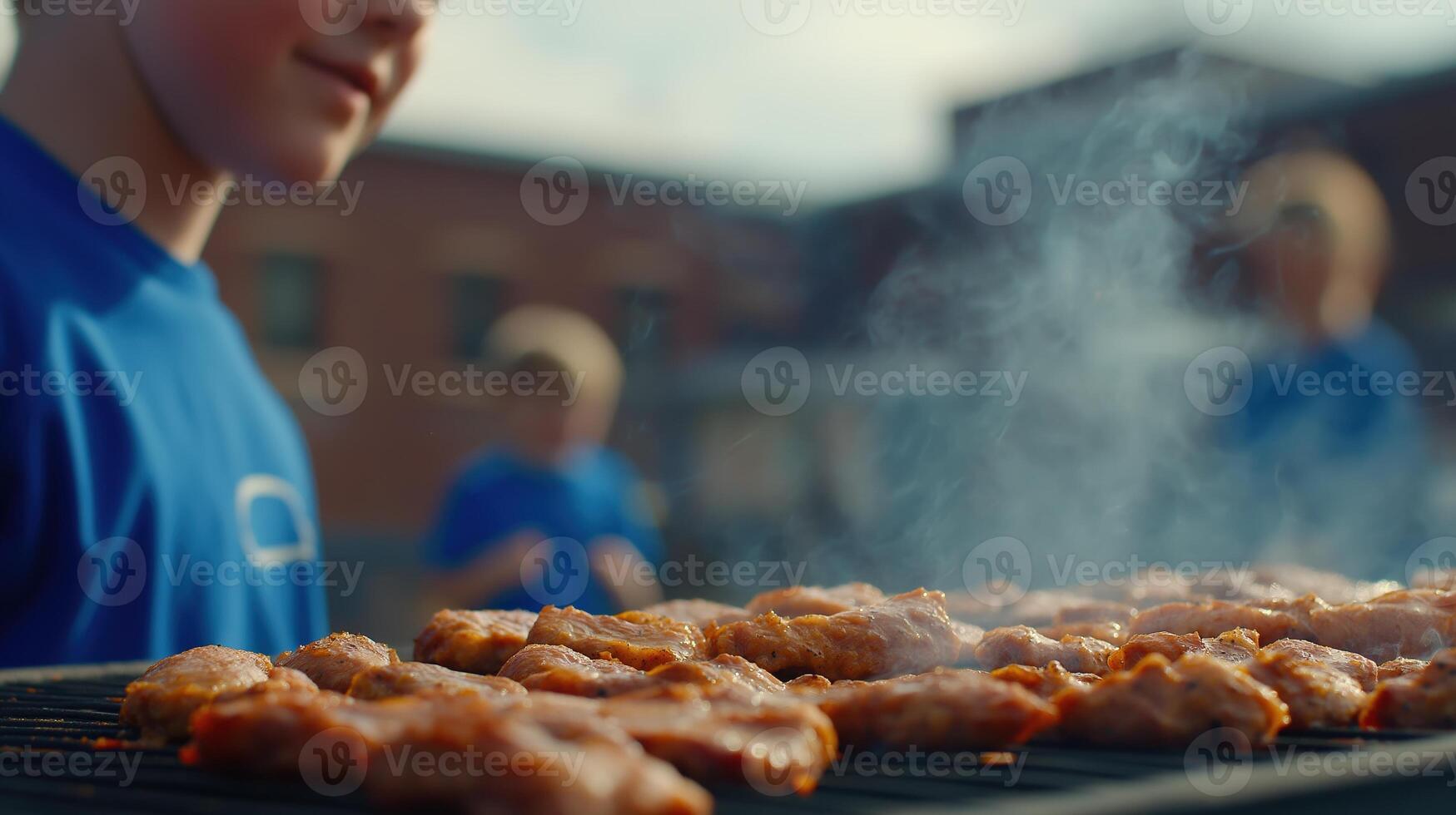 Young Boy Grilling Chicken on Barbecue With Friends in a Summer Outdoor Setting, Focusing on Food Preparation photo