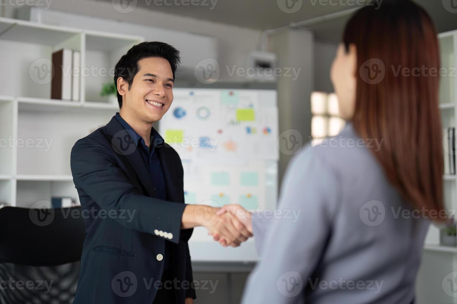 Networking and Professional Relations. A business associate exchanging a handshake in a modern office. photo