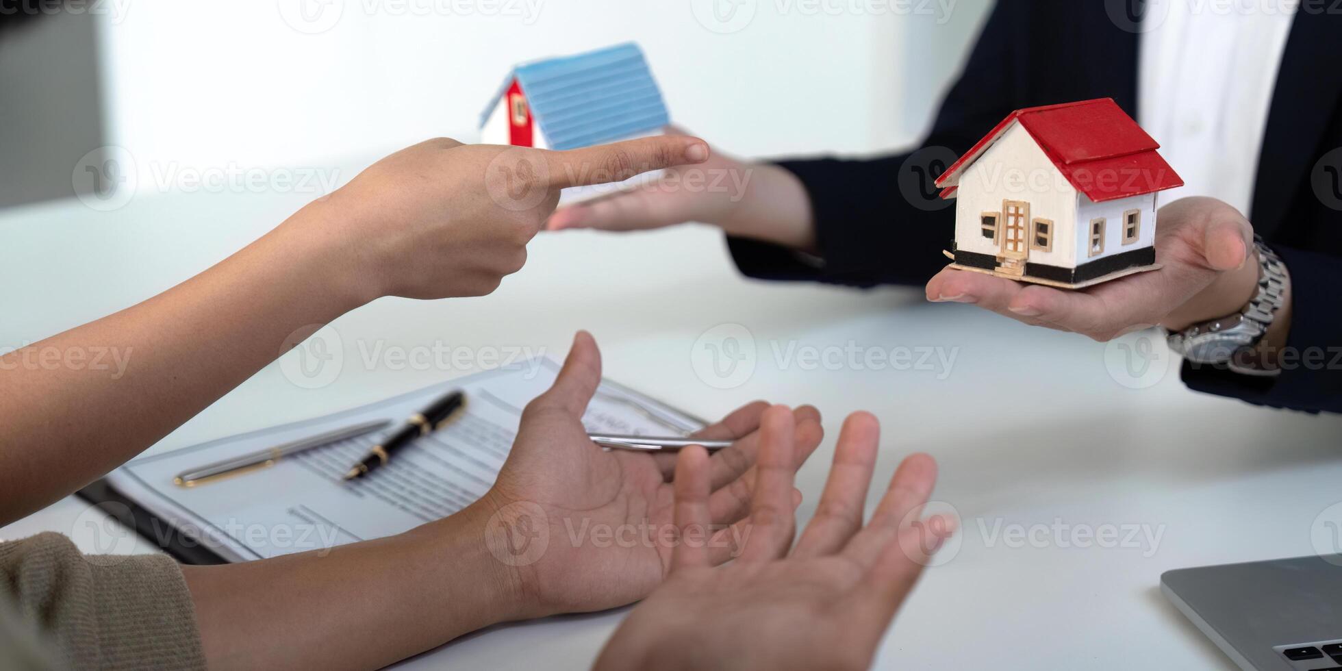 Negotiation and Decision-Making in Real Estate. A couple facilitates a discussion with their agent about property options. photo