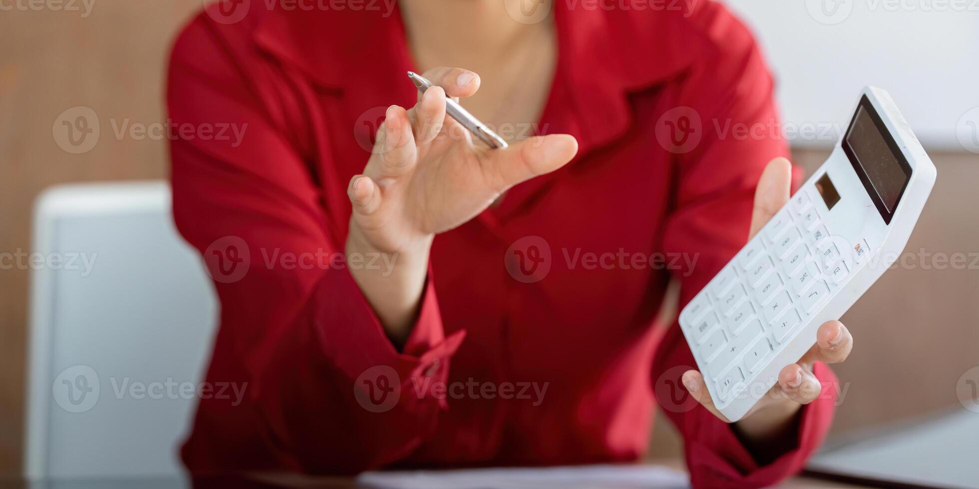 Calculating Finance Online. A professional actively engages in financial calculations while discussing reports. photo