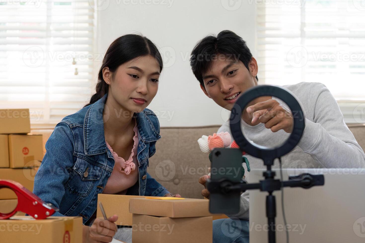 Creativity in E-Commerce. A couple discussing product features while preparing for a live unboxing session. photo