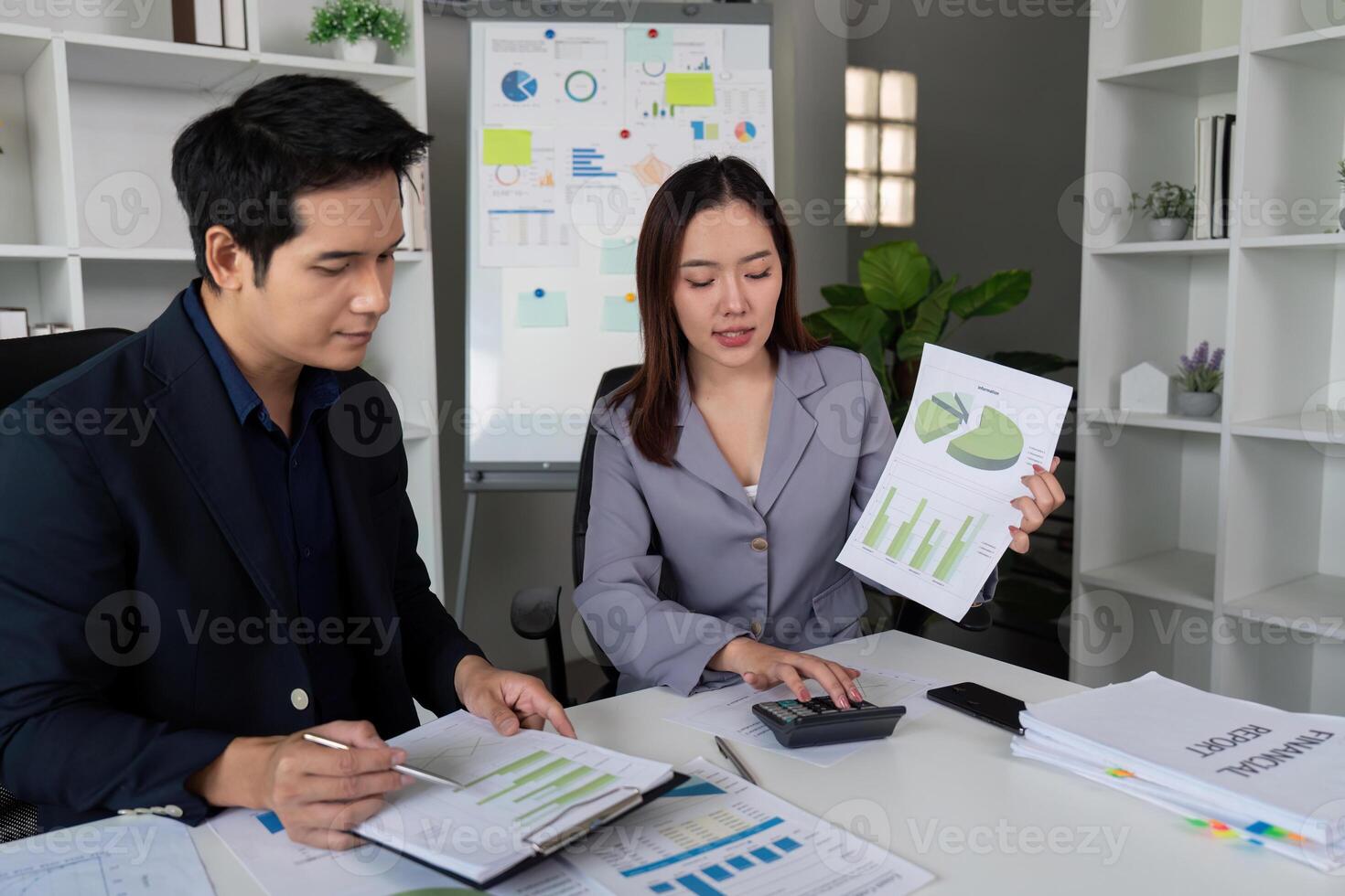 Team Collaboration and Financial Review. Colleagues analyzing financial data while showcasing a report. photo