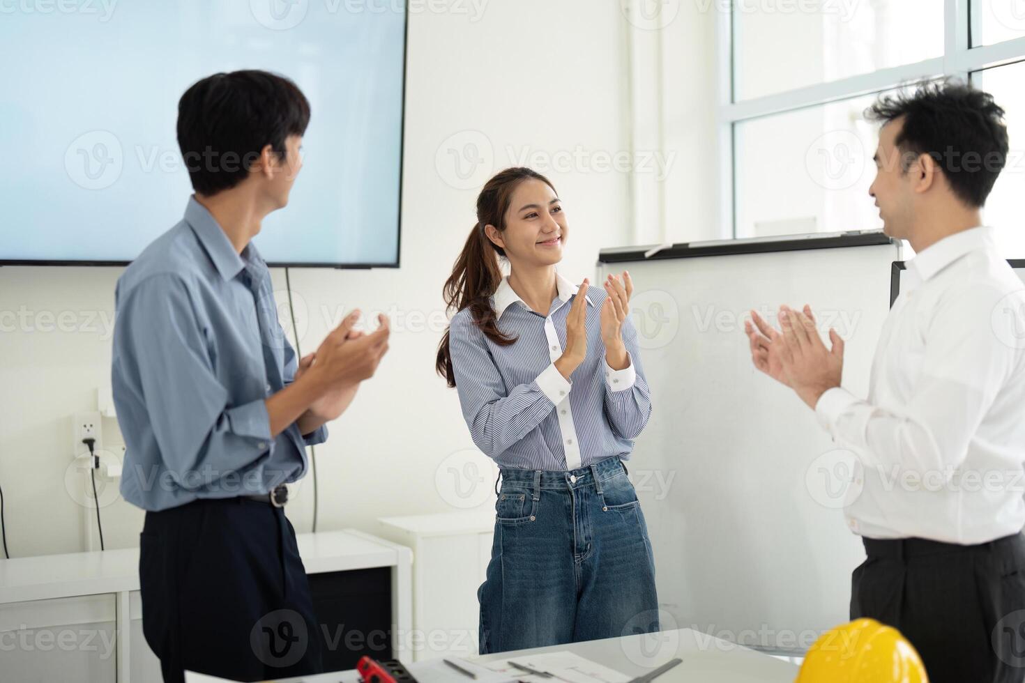 Positive Work Environment and Team Recognition. Architects and engineers applaud each other's contributions. photo