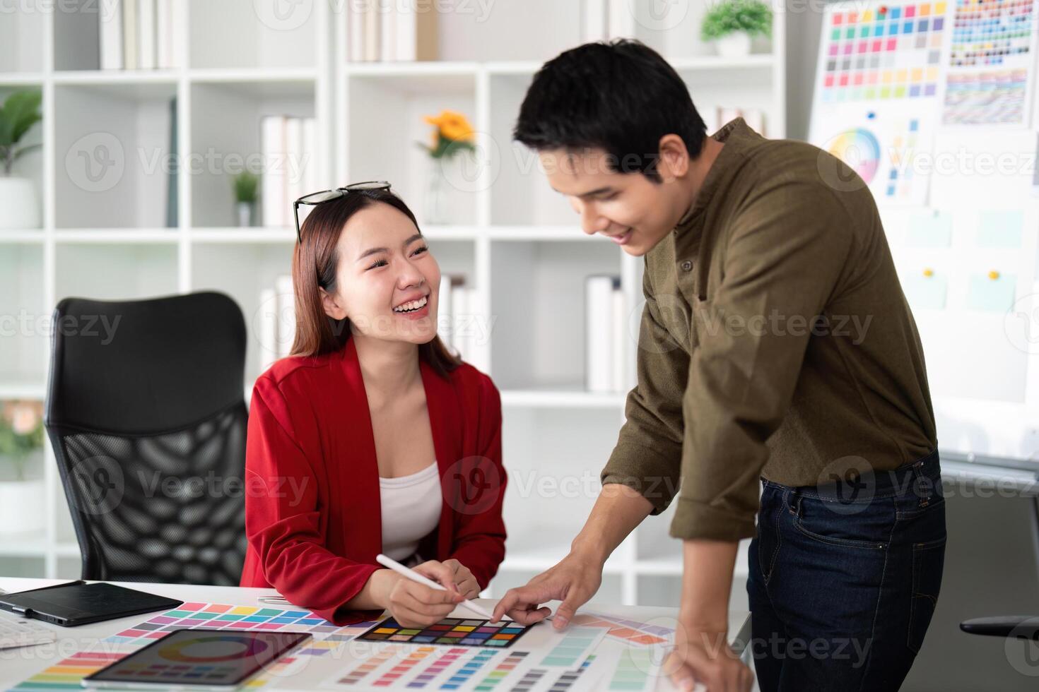 Collaboration and Inspiration. Two designers discuss color choices while enjoying a productive workspace vibe. photo