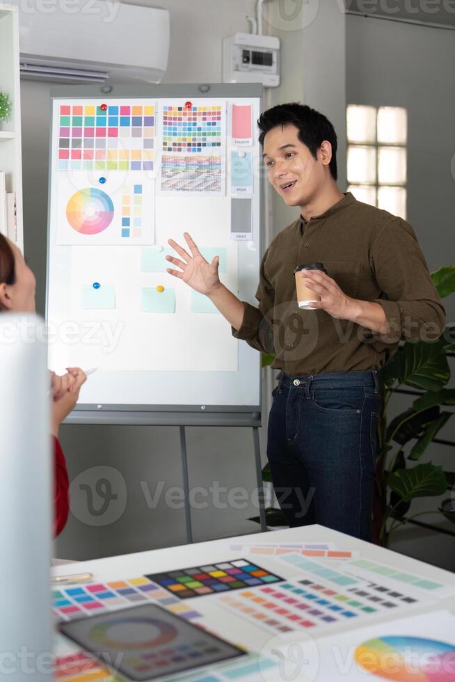 Presentation and Feedback in Design. A designer presenting ideas with a color board in a collaborative setting. photo