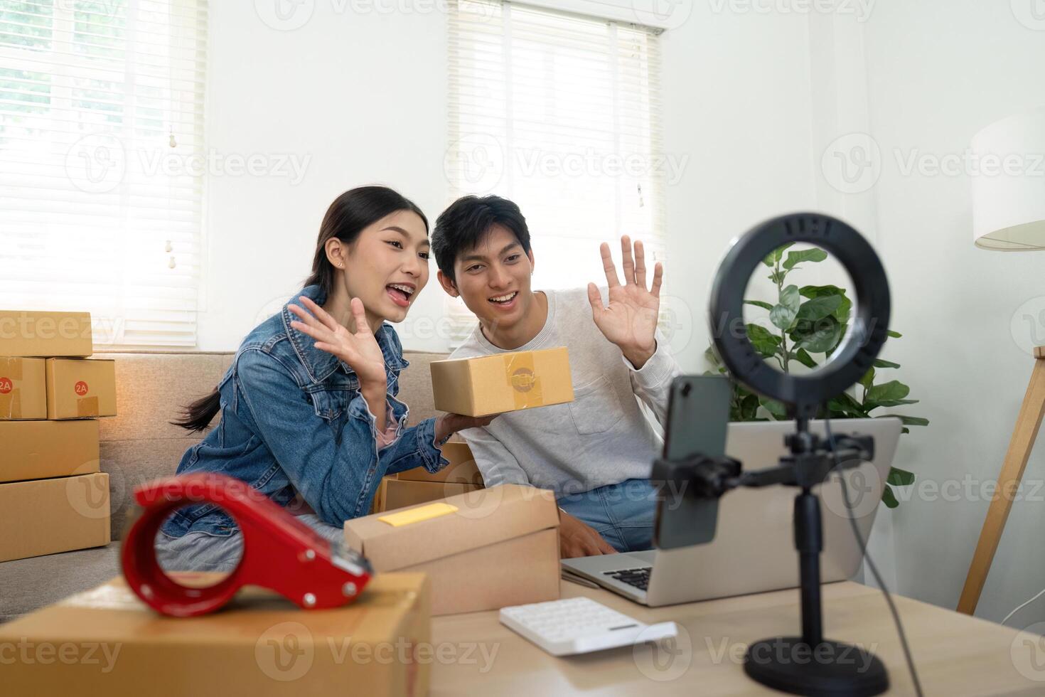 Entrepreneurship and Engagement. Couple streaming live while showcasing their new products. photo