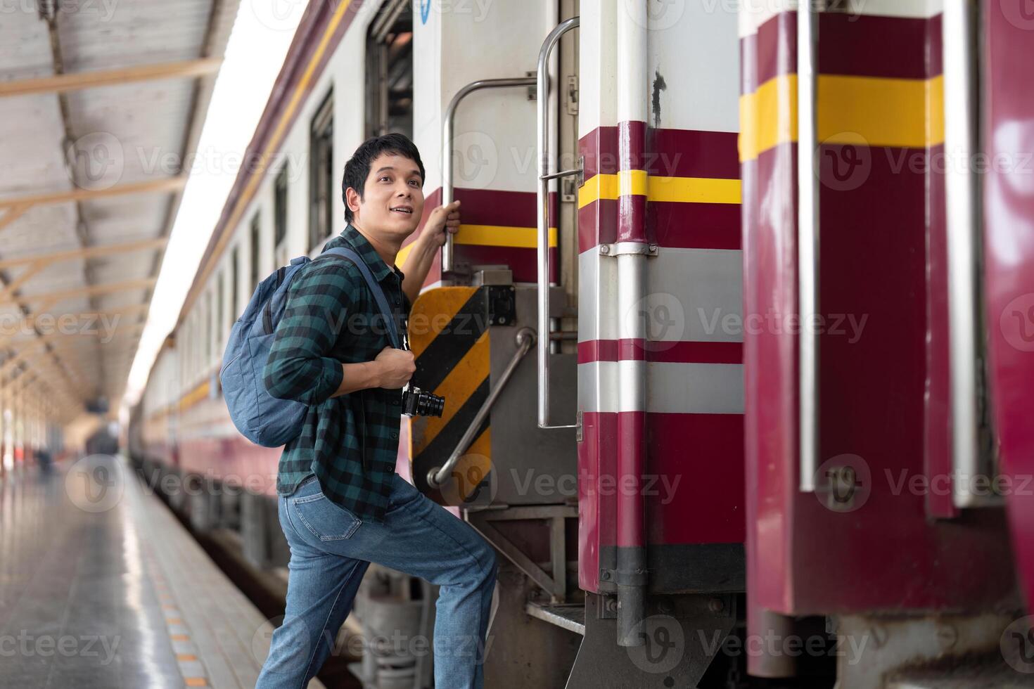 Journey and Adventure. A young traveler boards a train with a camera. photo