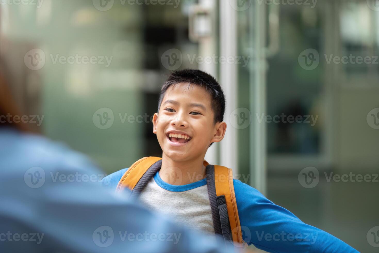 Back to School and Connection. A son expresses joy as he opens his arms to his mother. photo