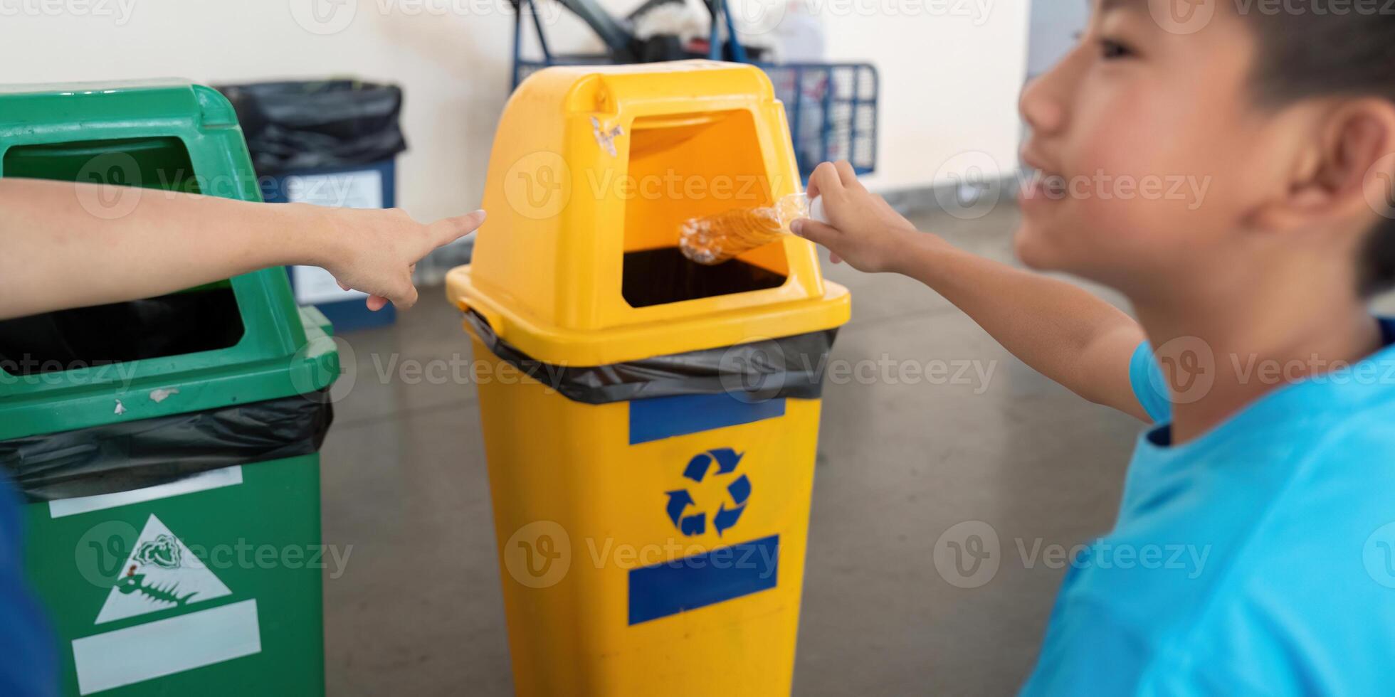 Recycling and Education. A child learning to recycle while actively engaging with recycling bins. photo