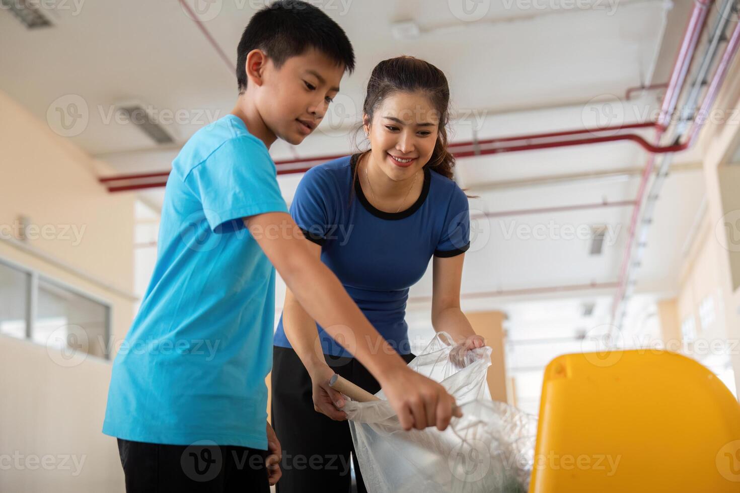 Community and Eco-Friendliness. A young person assists in recycling efforts, working together to create a cleaner environment. photo