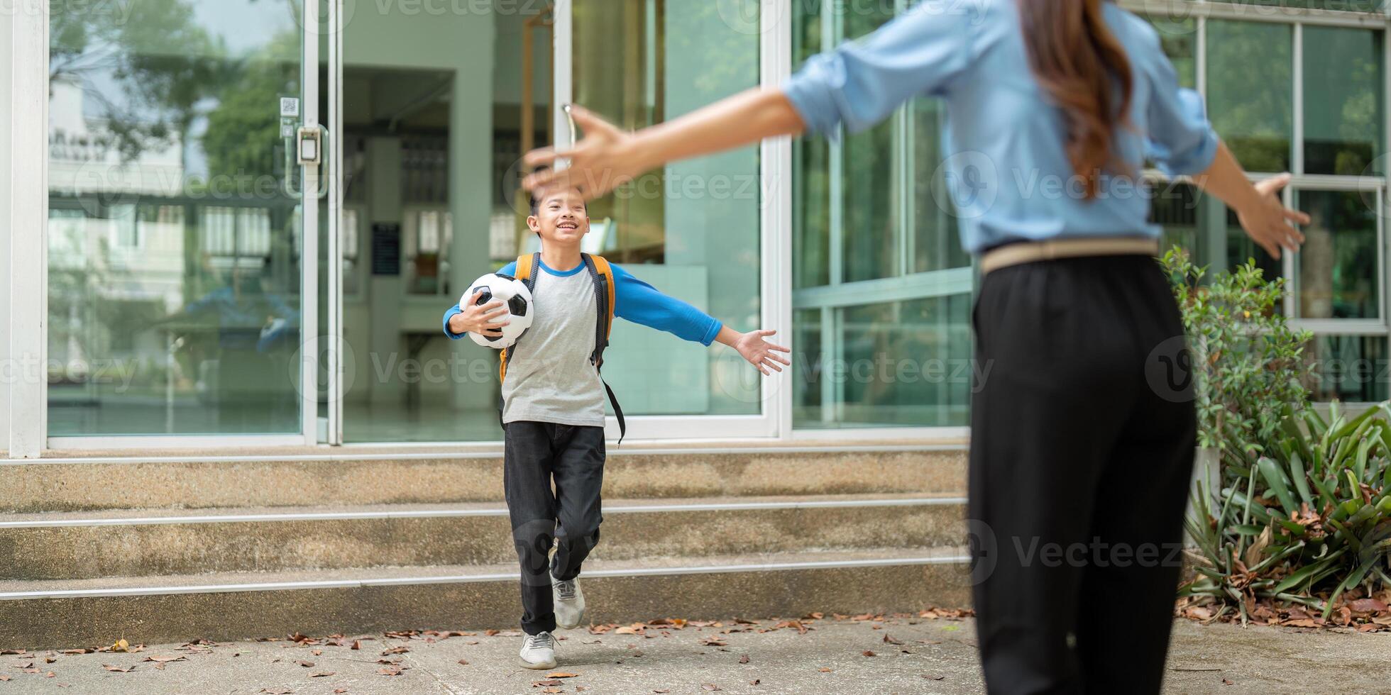 Celebrating Arrival and Connection. A child joyfully runs to greet a parent after school, showcasing love and support. photo