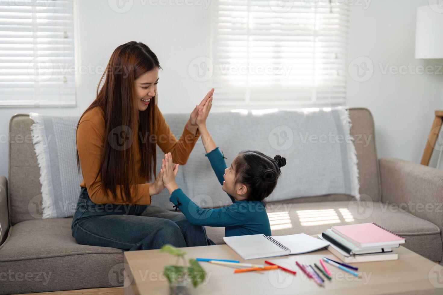 Playful Learning and Family Fun. A mother and daughter enjoying a hand-clapping game. photo