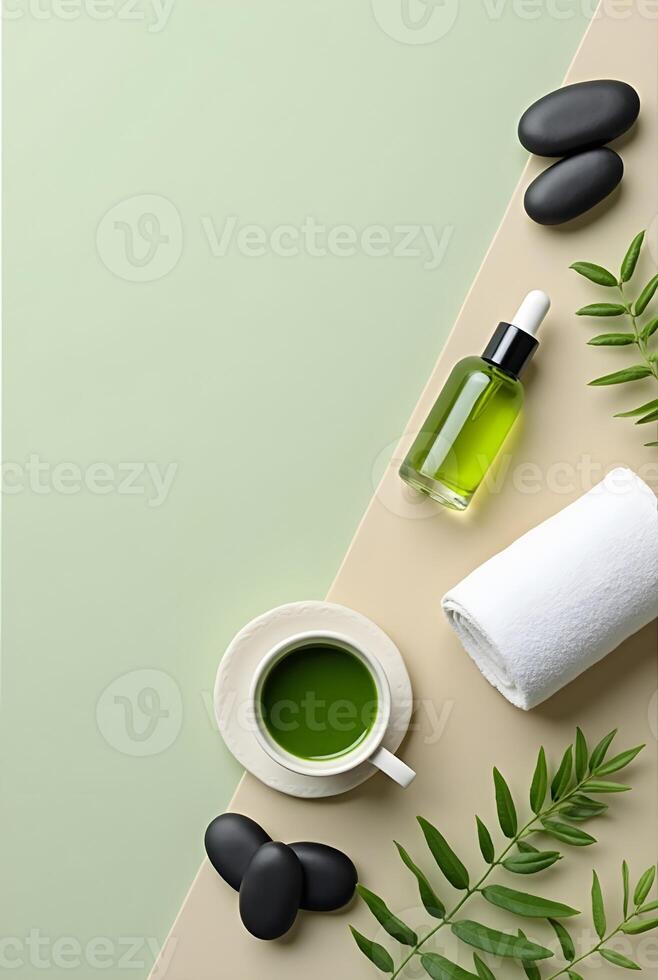 Overhead view of matcha tea, spa stones, towel, and flowers on a pastel green background photo