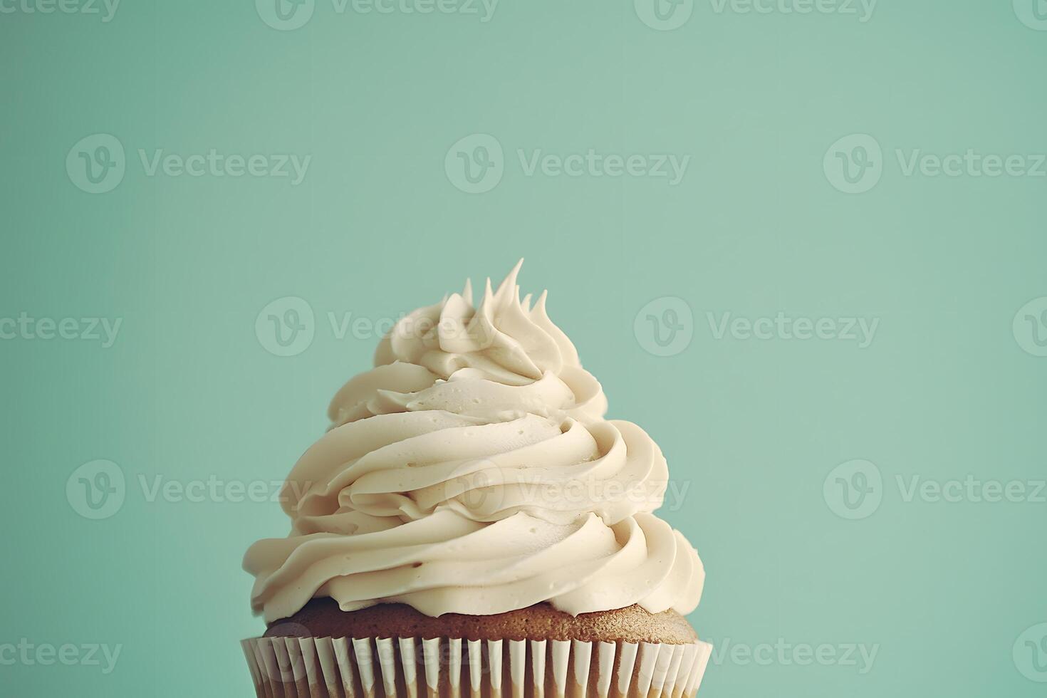Delicious Vanilla Cupcake with Creamy Frosting on Mint Background photo