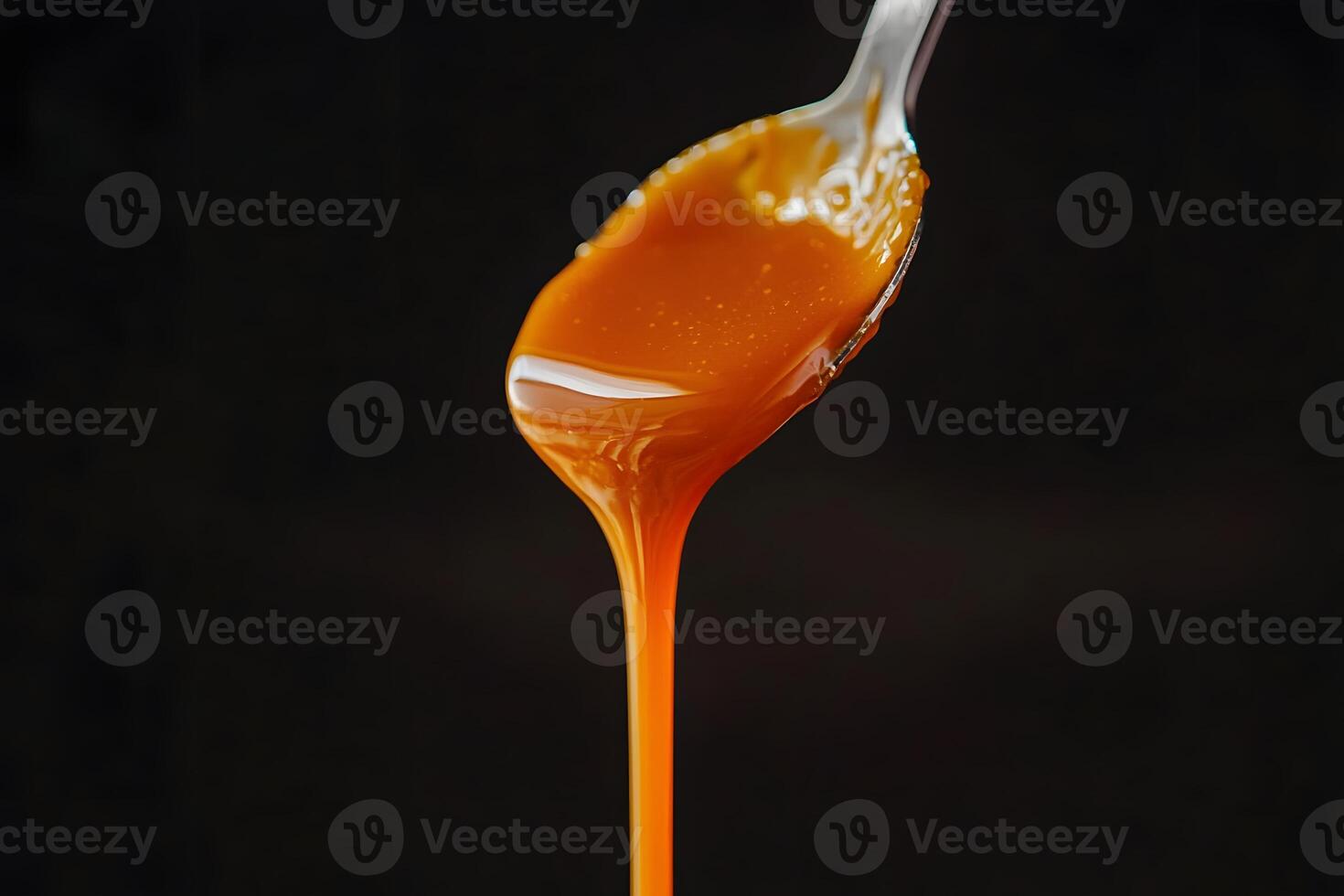 Delicious Caramel Sauce Dripping from a Spoon Close up Food Photography Sweet Treat photo