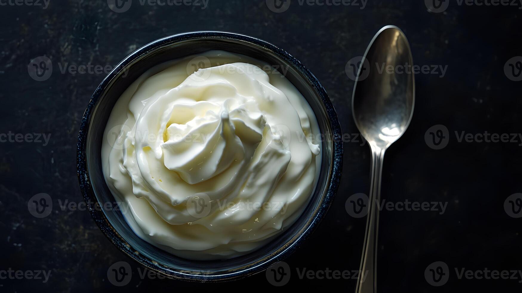 Yogurt in a bowl with a spoon photo
