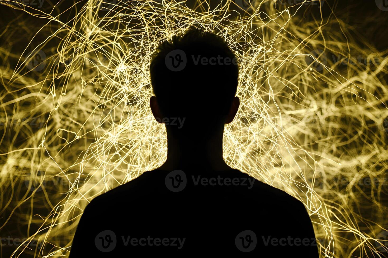 A man is silhouetted against a glowing yellow light photo