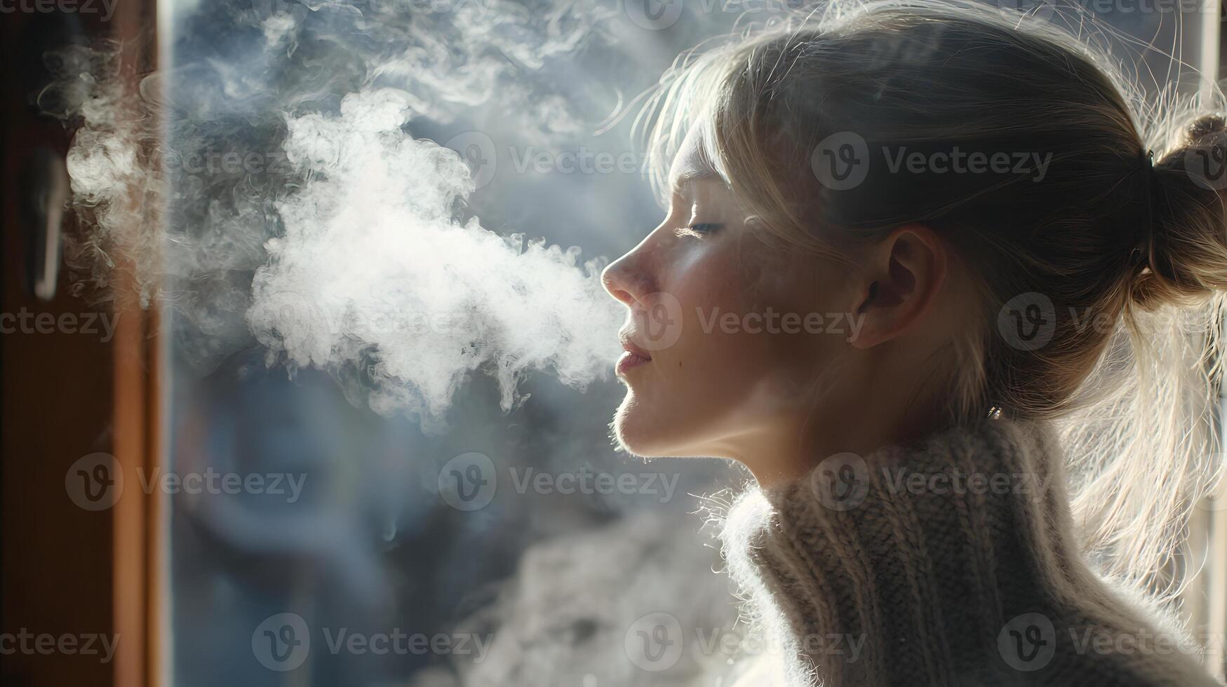 A woman is smoking a cigarette outside photo