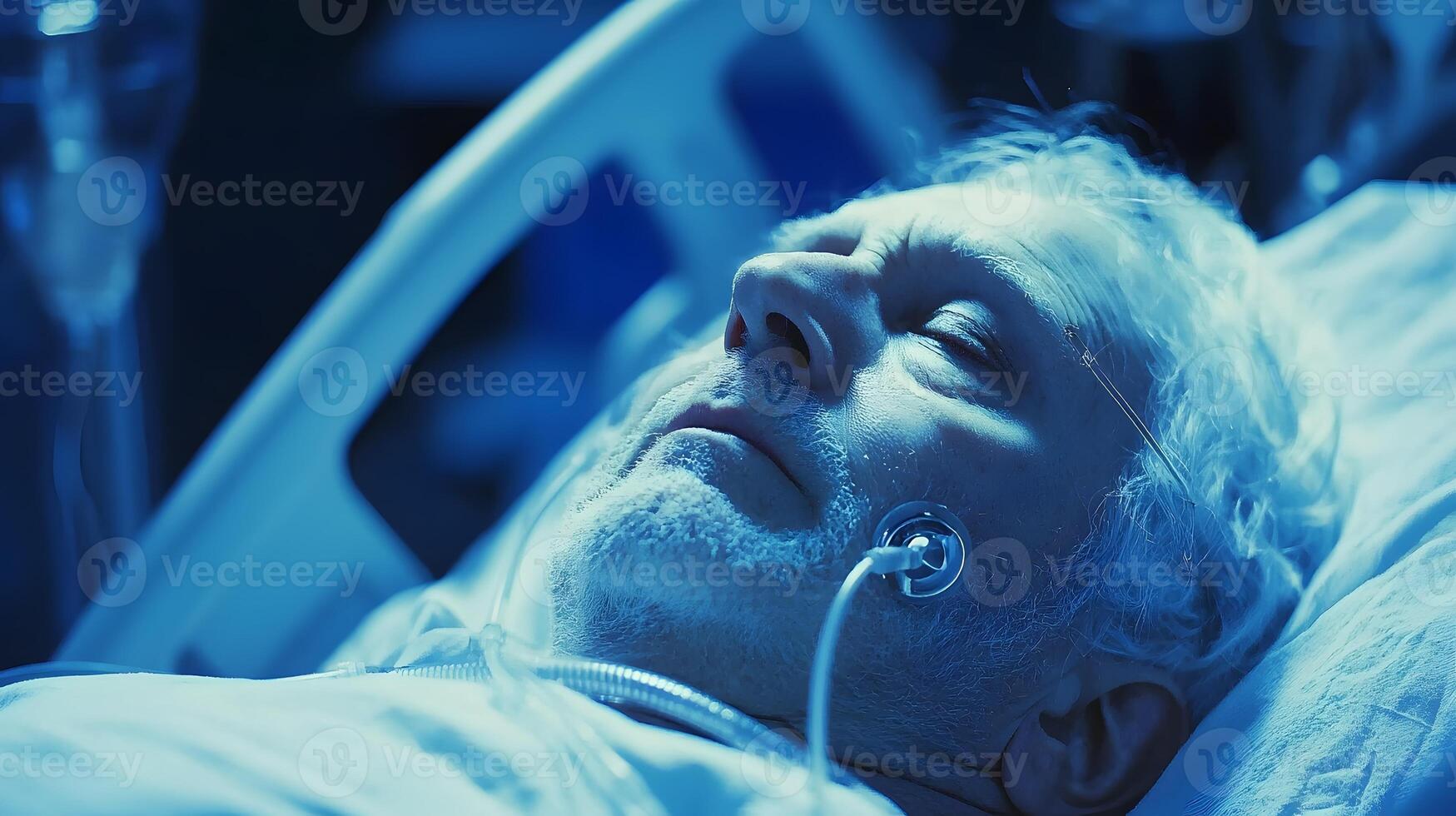 A man in a hospital bed with a breathing tube photo