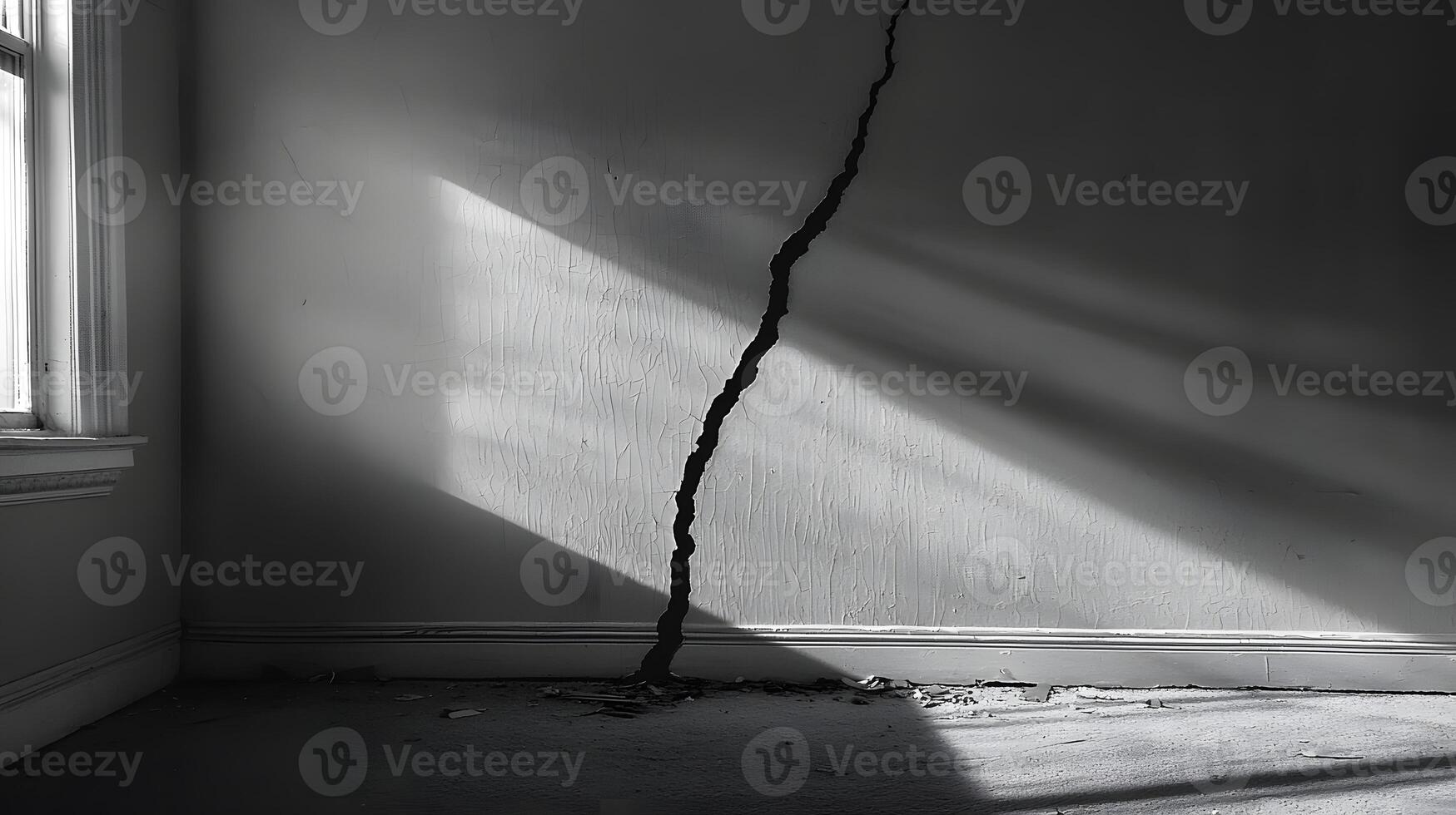 Dramatic Crack in Old Wall Sunlight Illuminates Damage Interior Room Grey tones photo