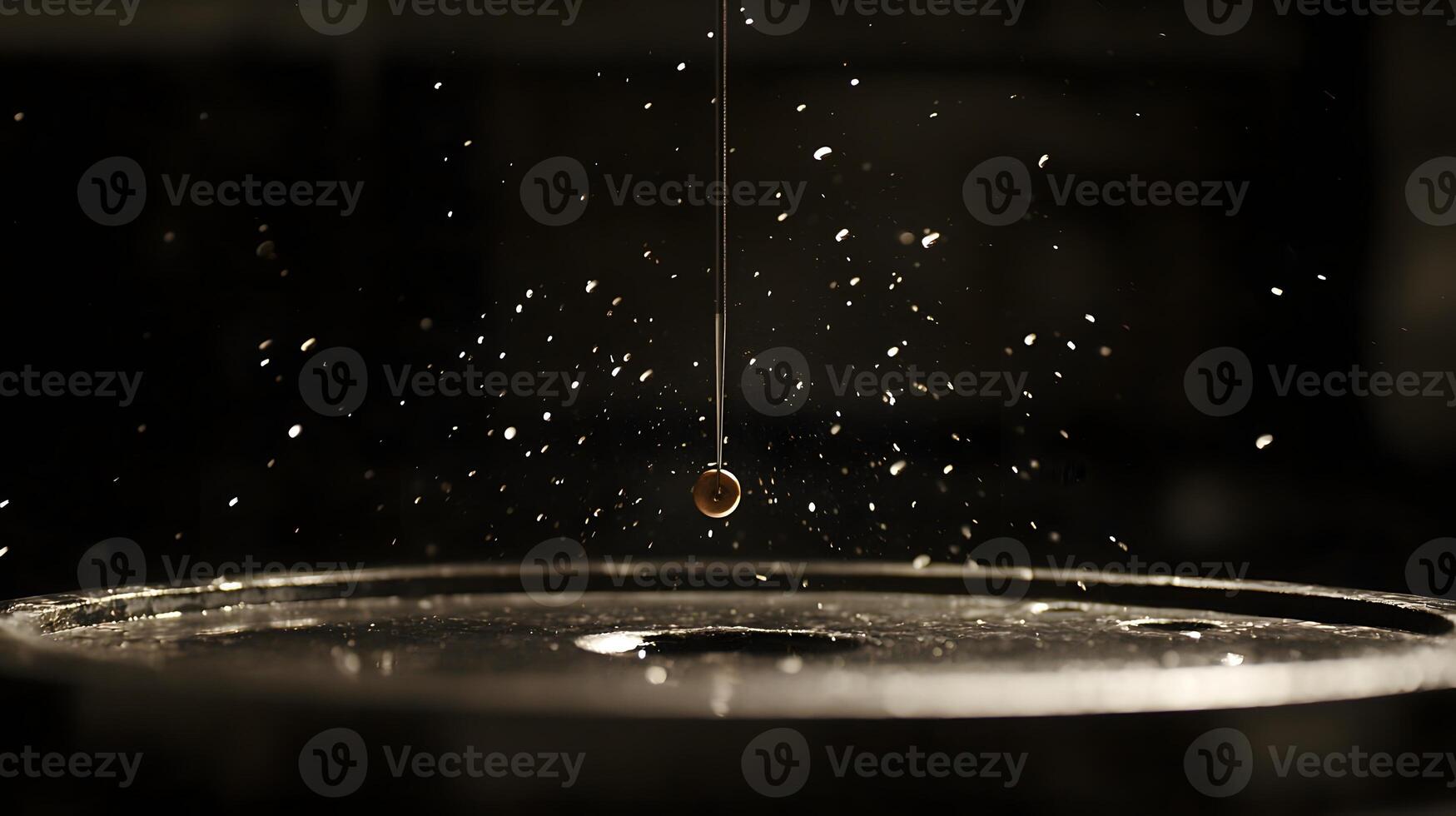 Abstract Pendulum Swinging Over Dark Surface with Water Droplets photo