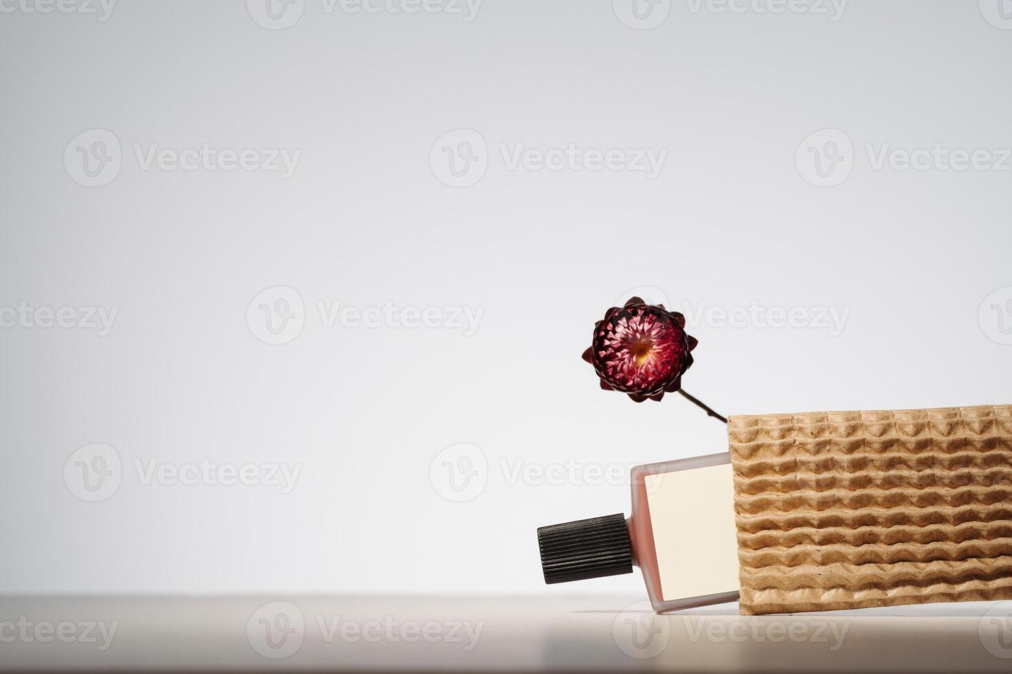 Blank beauty product in recycled delivery packaging. Minimalist mockup with dry flower photo