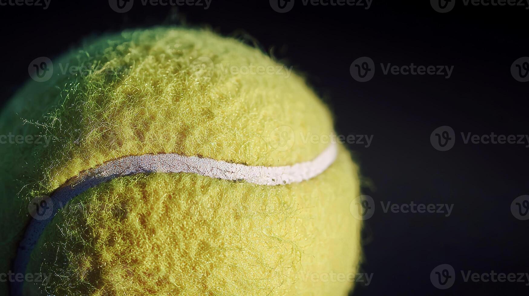 Close-Up of a Fuzzy Tennis Ball Against a Dark Background photo